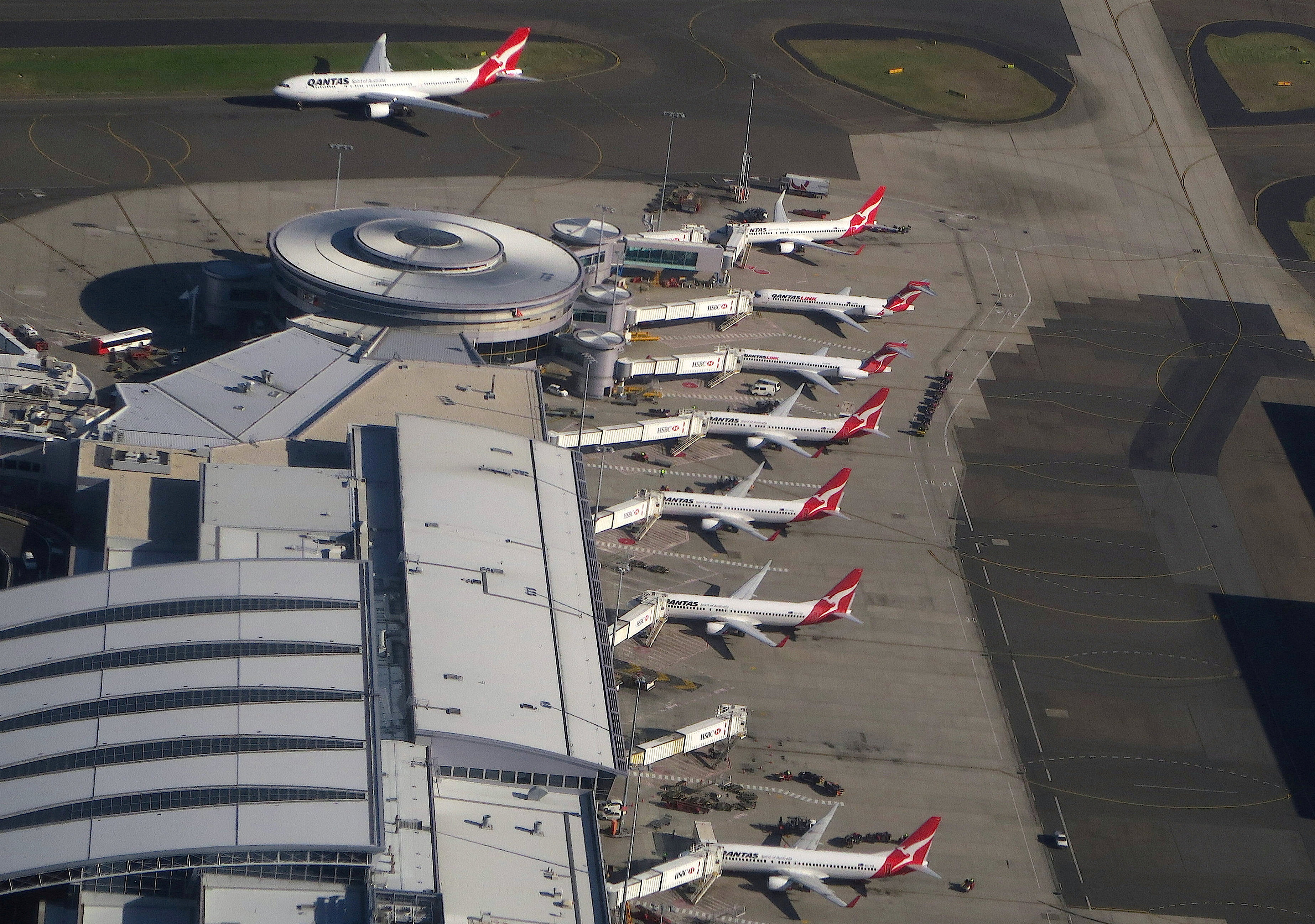 Qantas Airways planes are parked at the domestic terminal at Sydney airport in Australia