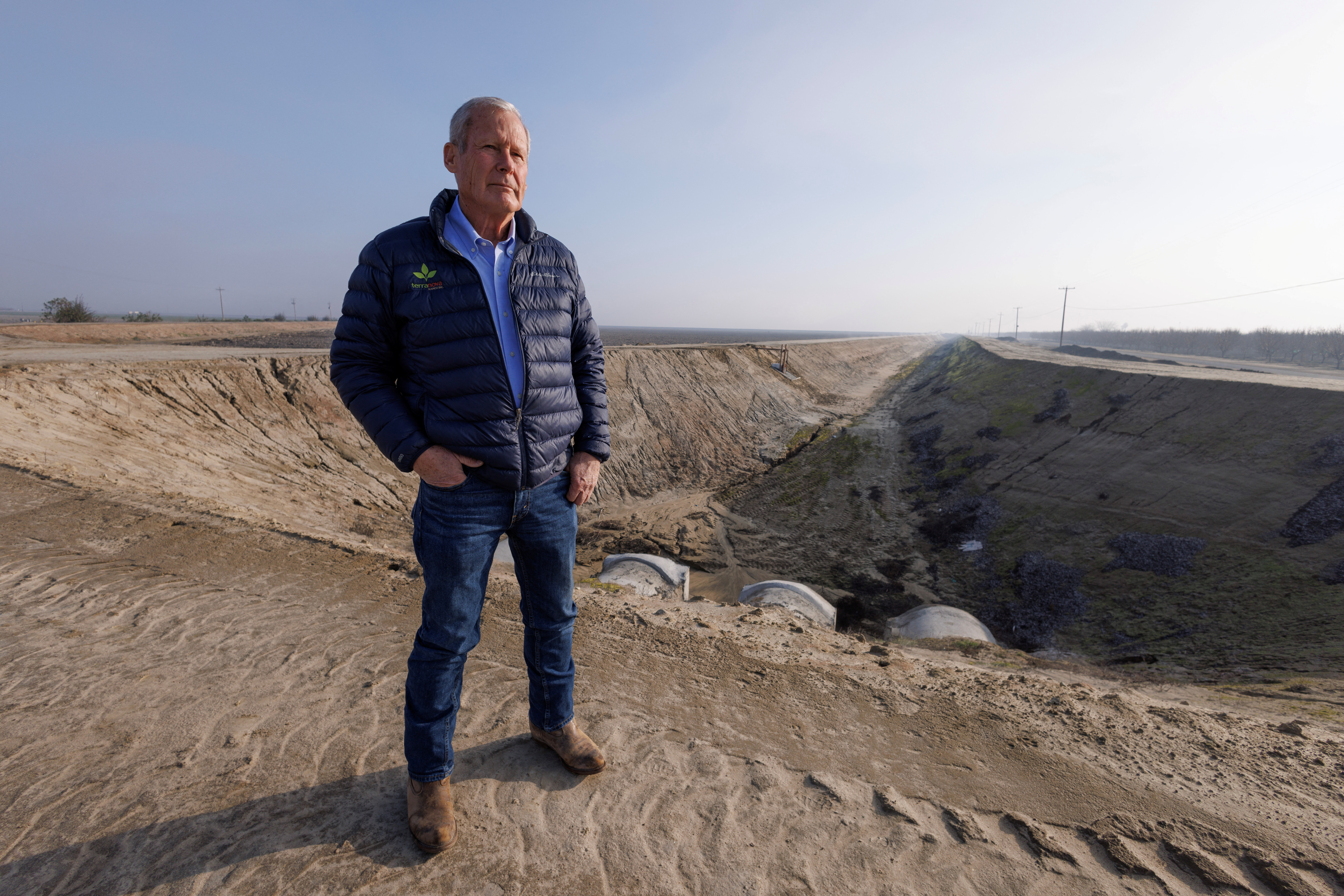 Don Cameron stands next to one of his flood capture projects on his Terranova Ranch in Helm, California