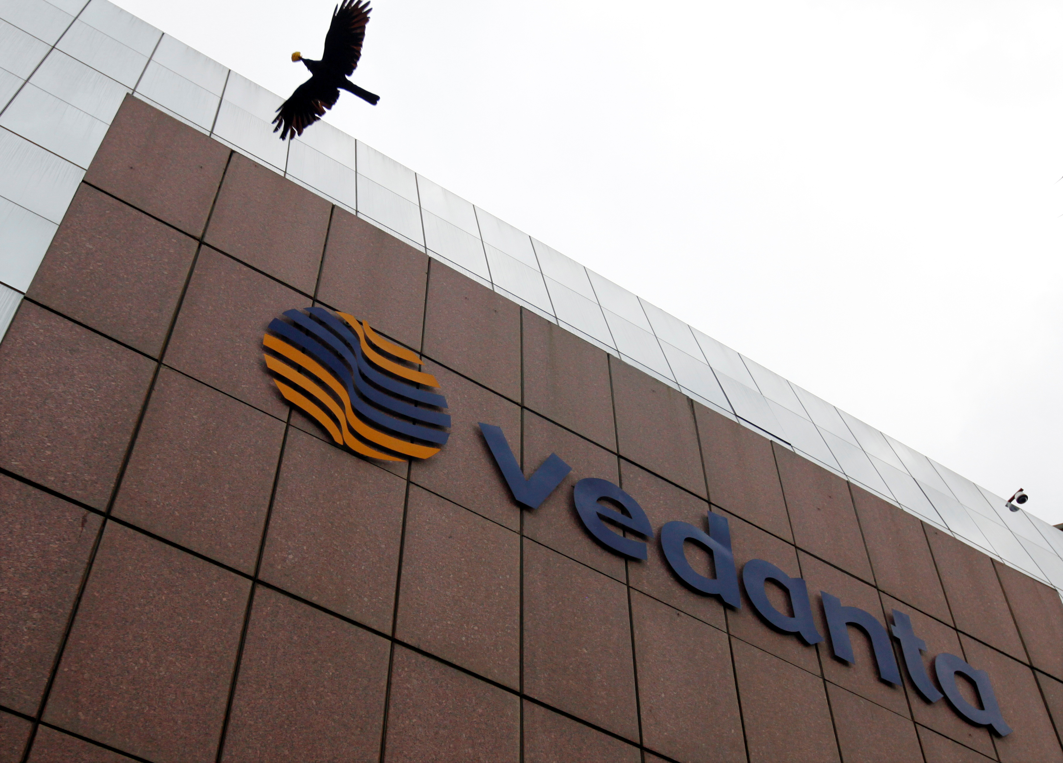A bird flies by the Vedanta office building in Mumbai