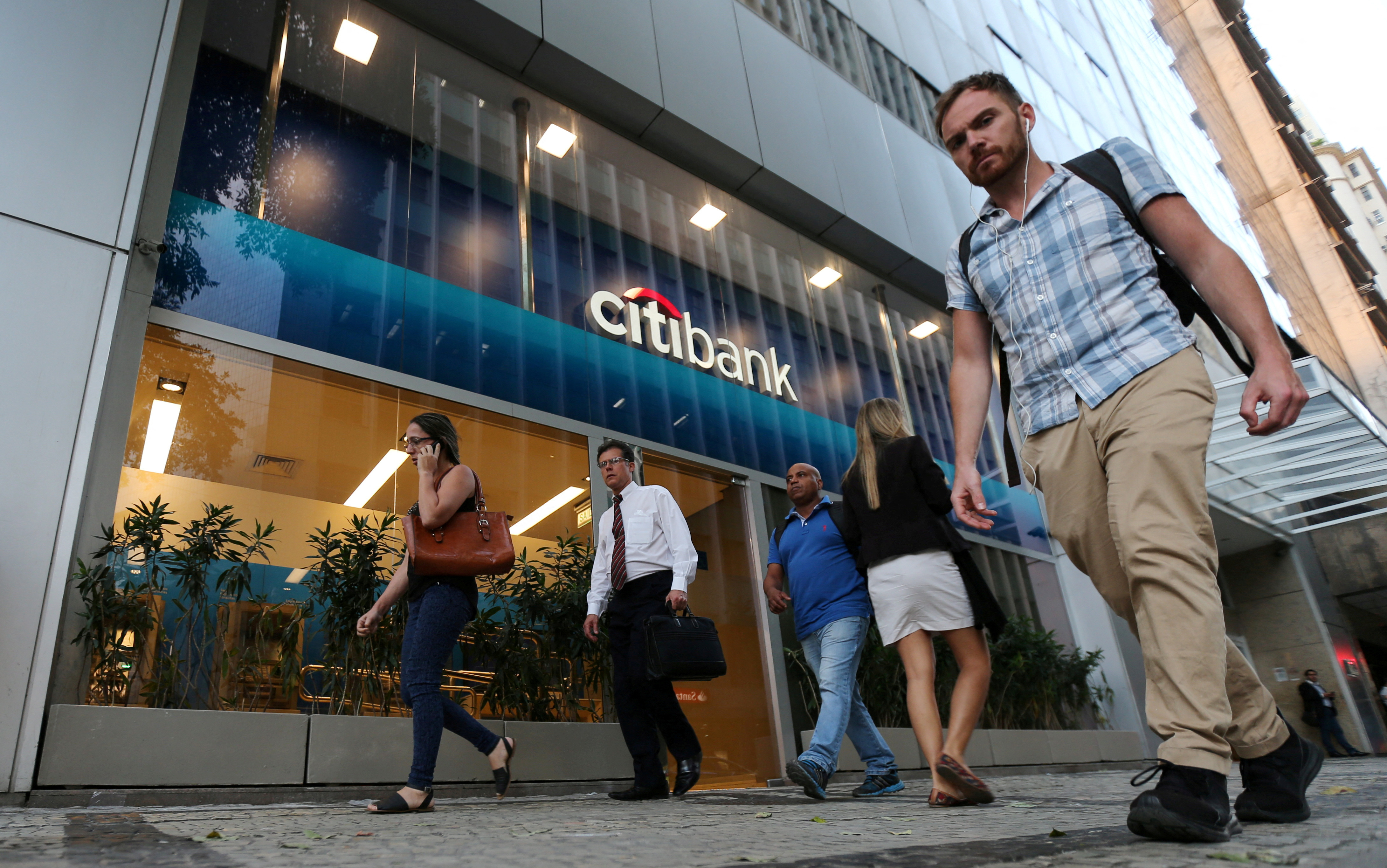 People walk past a Citibank branch in Rio de Janeiro