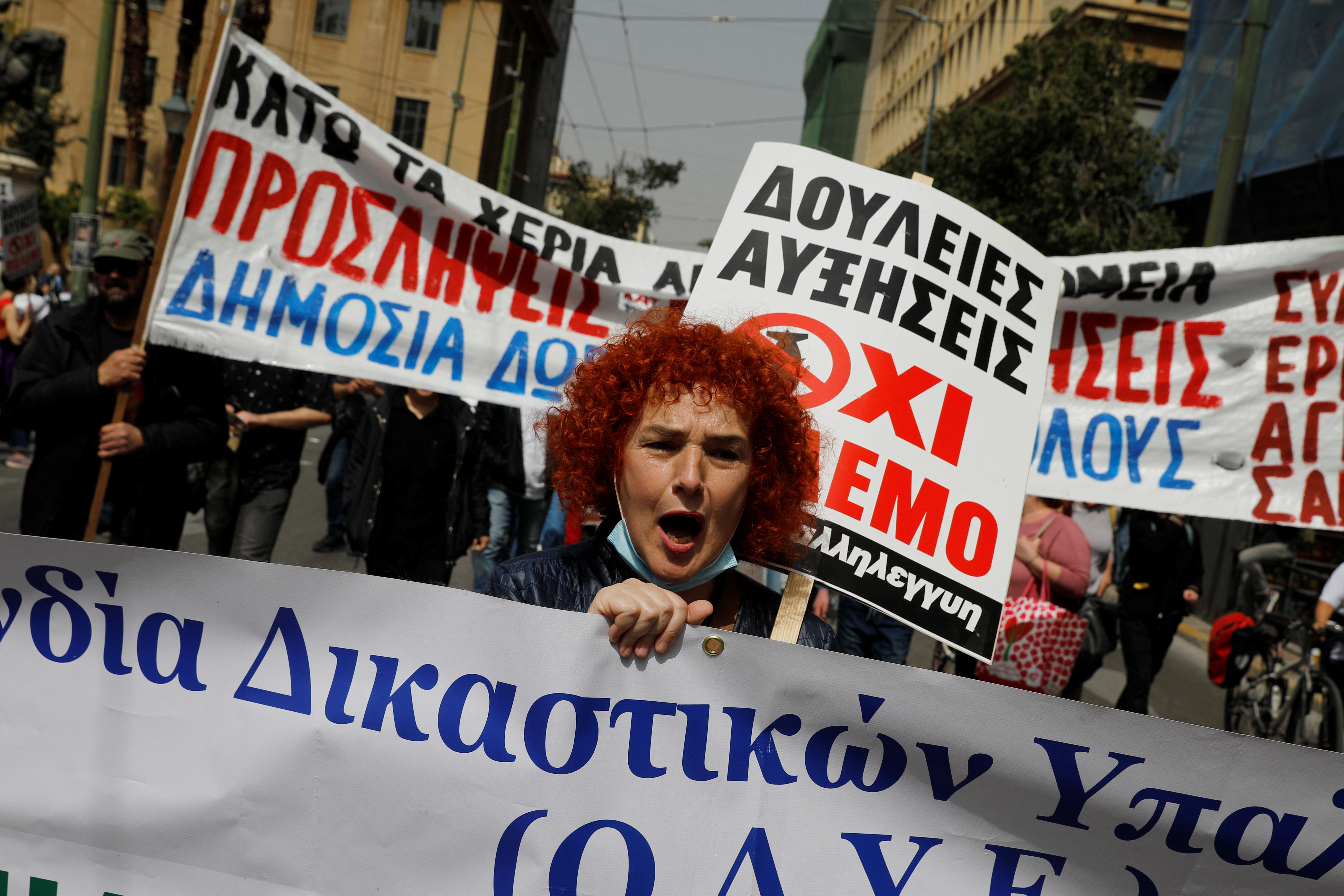 People take part in a protest during a 24-hour strike over high prices and low wages in Athens