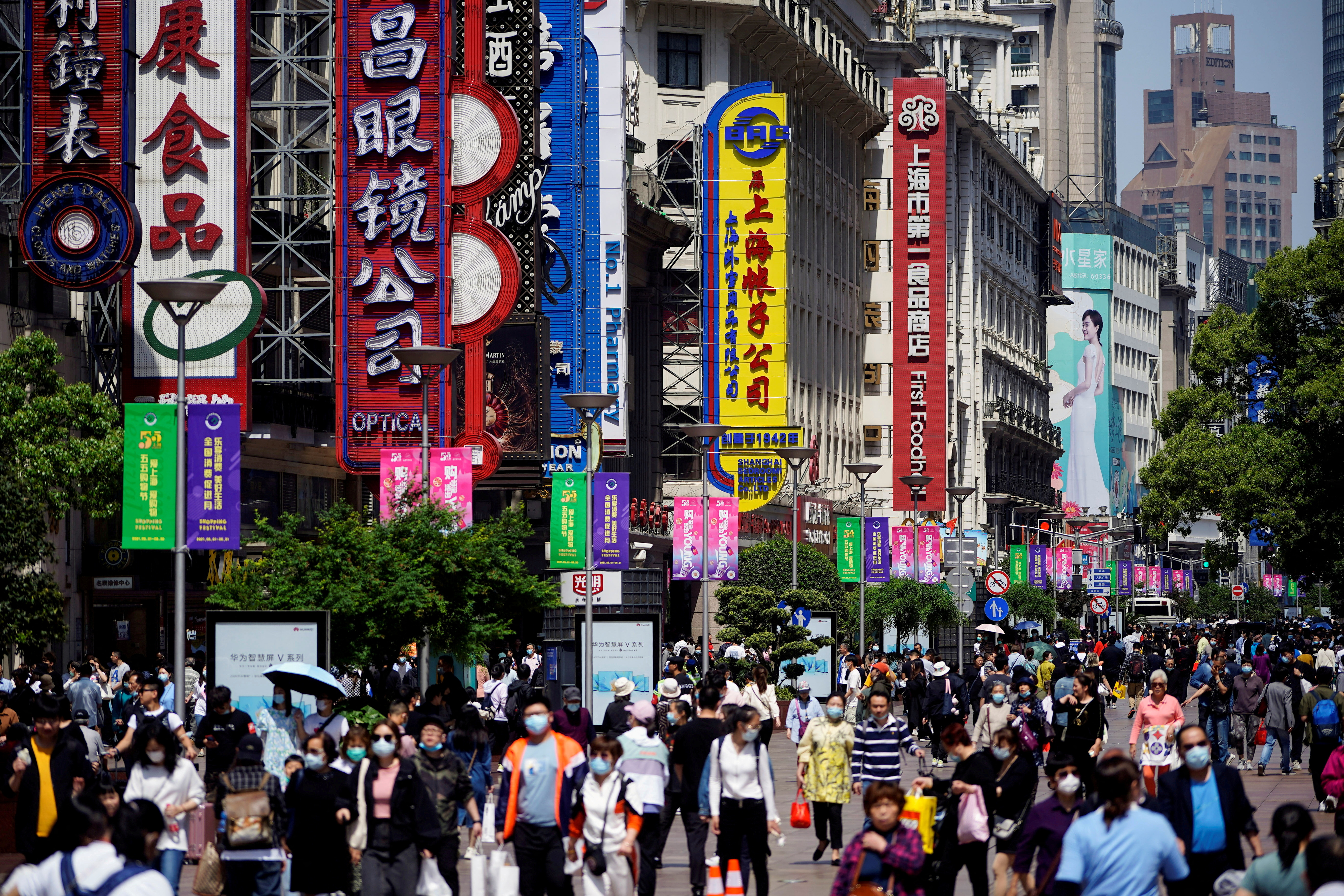 People walk along Nanjing Pedestrian Road during the Labour Day holiday in Shanghai