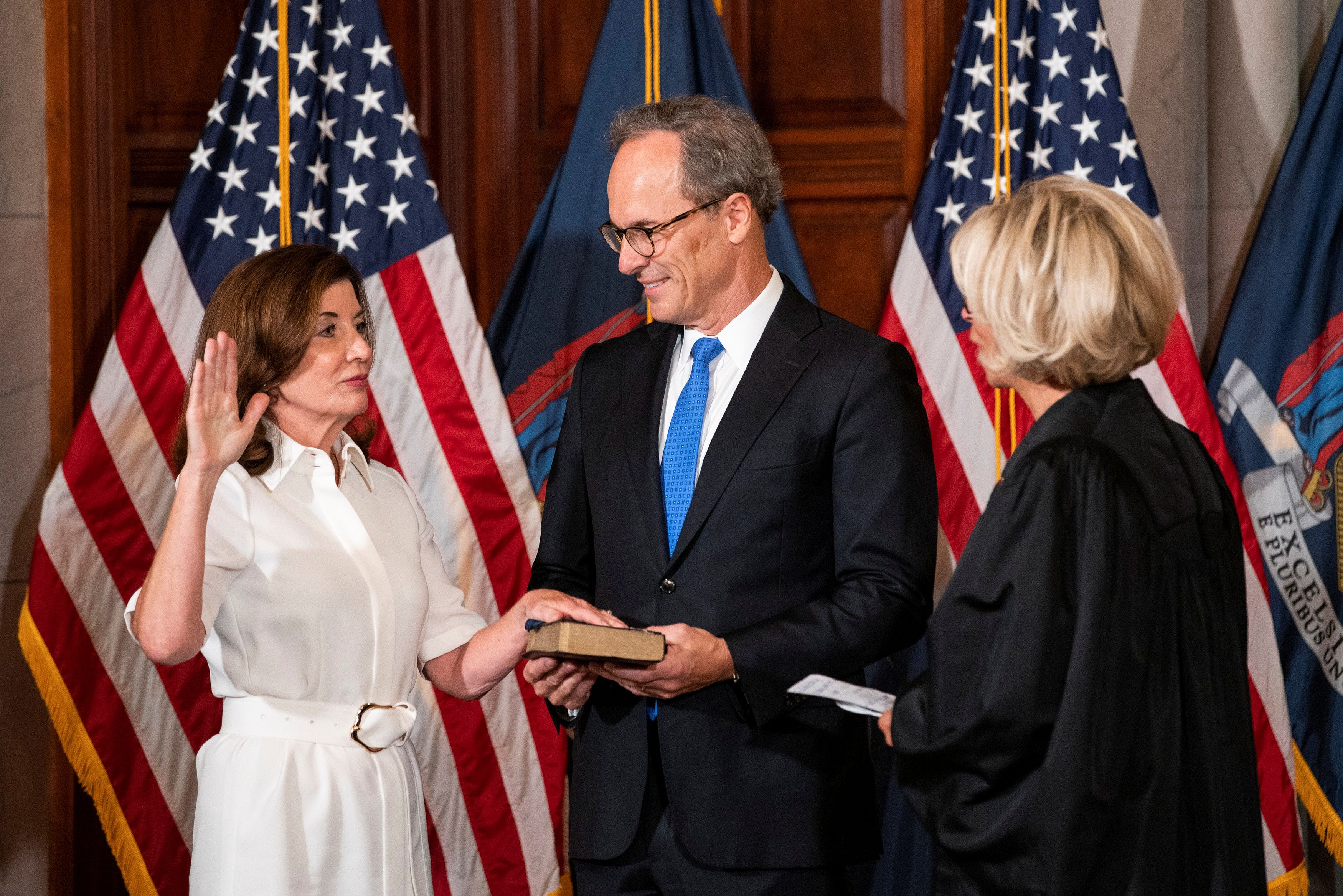 New York Governor Kathy Hochul takes part in a ceremonial swearing-in ceremony with her husband Bill Hochul and New York Chief Judge Janet DiFiore, to become New York State's 57th and first woman governor, in the Red Room at the New York State Capitol, in Albany, New York, U.S., August 24, 2021. REUTERS/Eduardo Munoz