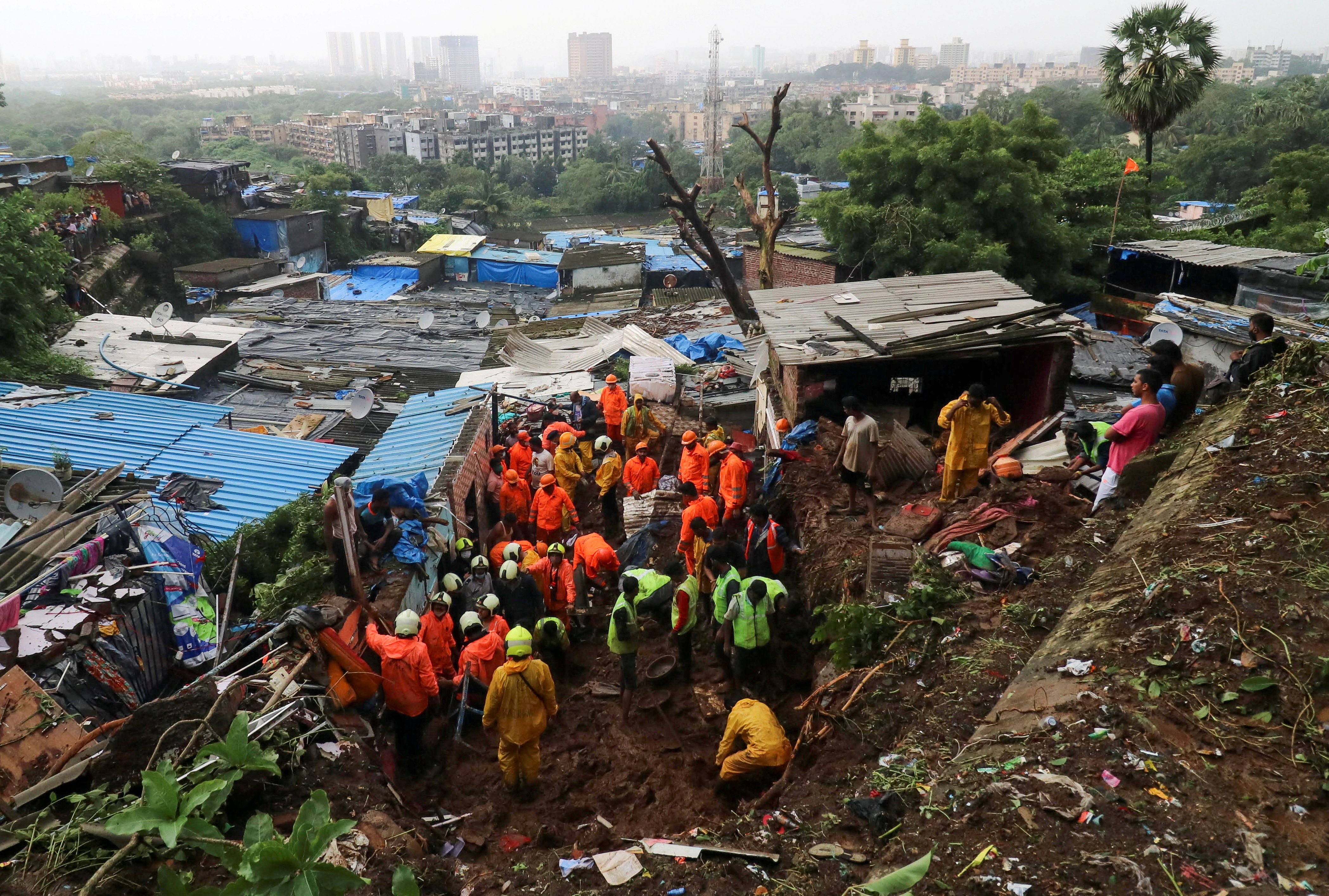 Rescue workers search for survivors after house collapse due to landslide in Mumbai