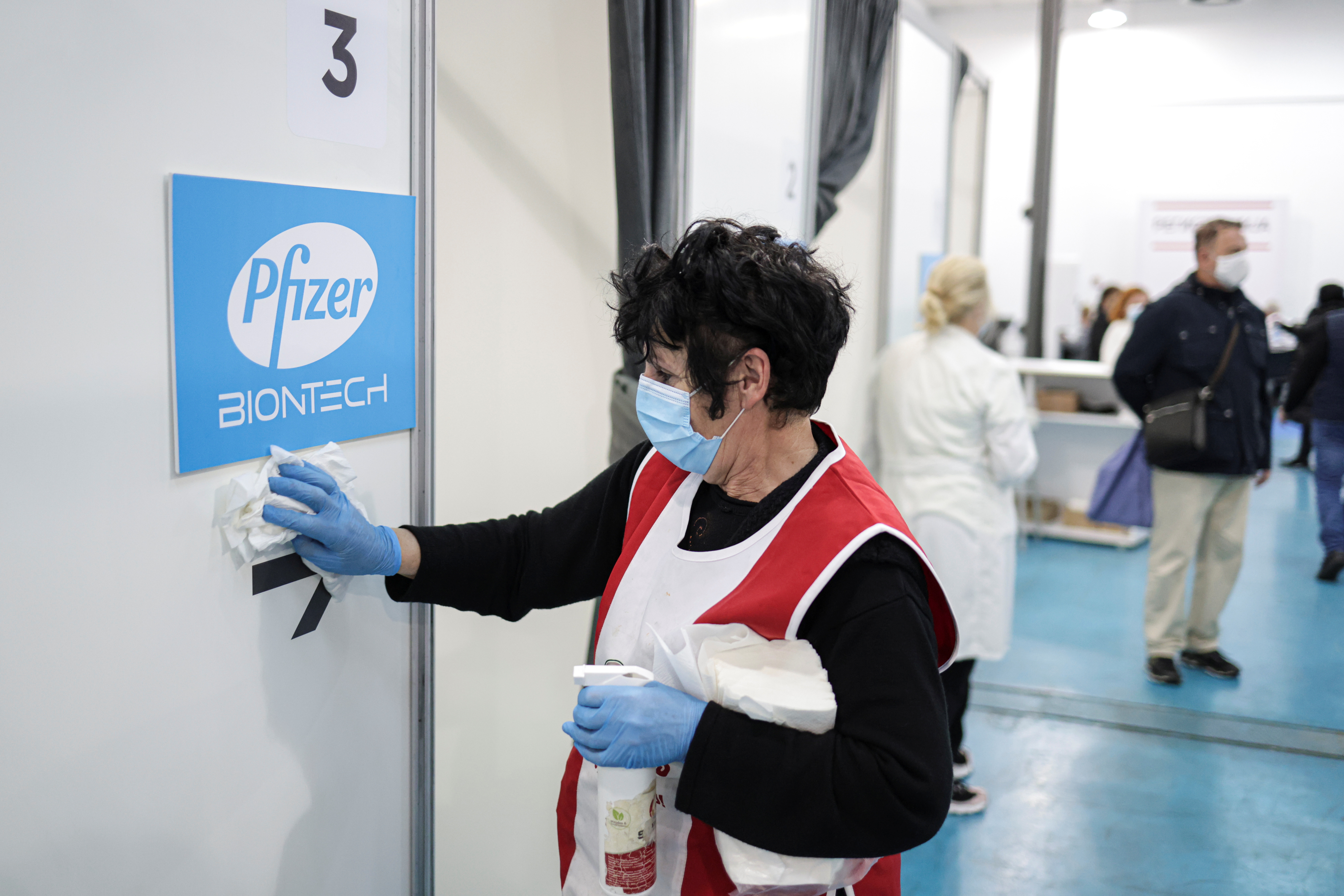 A healthcare worker disinfects a booth where people receive doses of Pfizer's coronavirus disease (COVID-19) vaccine at Belgrade Fair vaccination center in Belgrade, Serbia, October 15, 2021. REUTERS/Marko Djurica