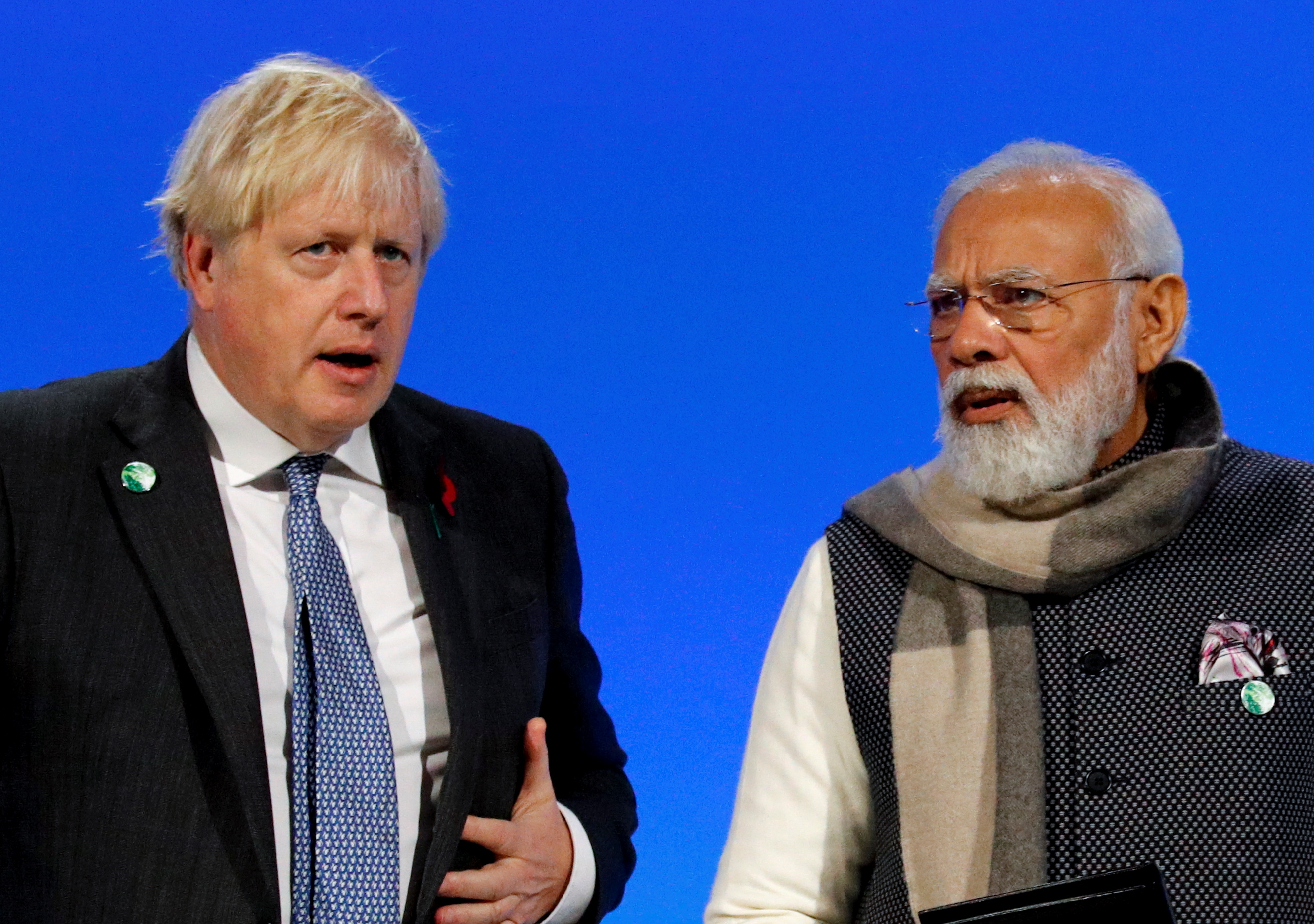 Britain's Prime Minister Boris Johnson and India's Prime Minister Narendra Modi attend a meeting during the UN Climate Change Conference (COP26) in Glasgow, Scotland, Britain, November 2, 2021. REUTERS/Phil Noble/Pool
