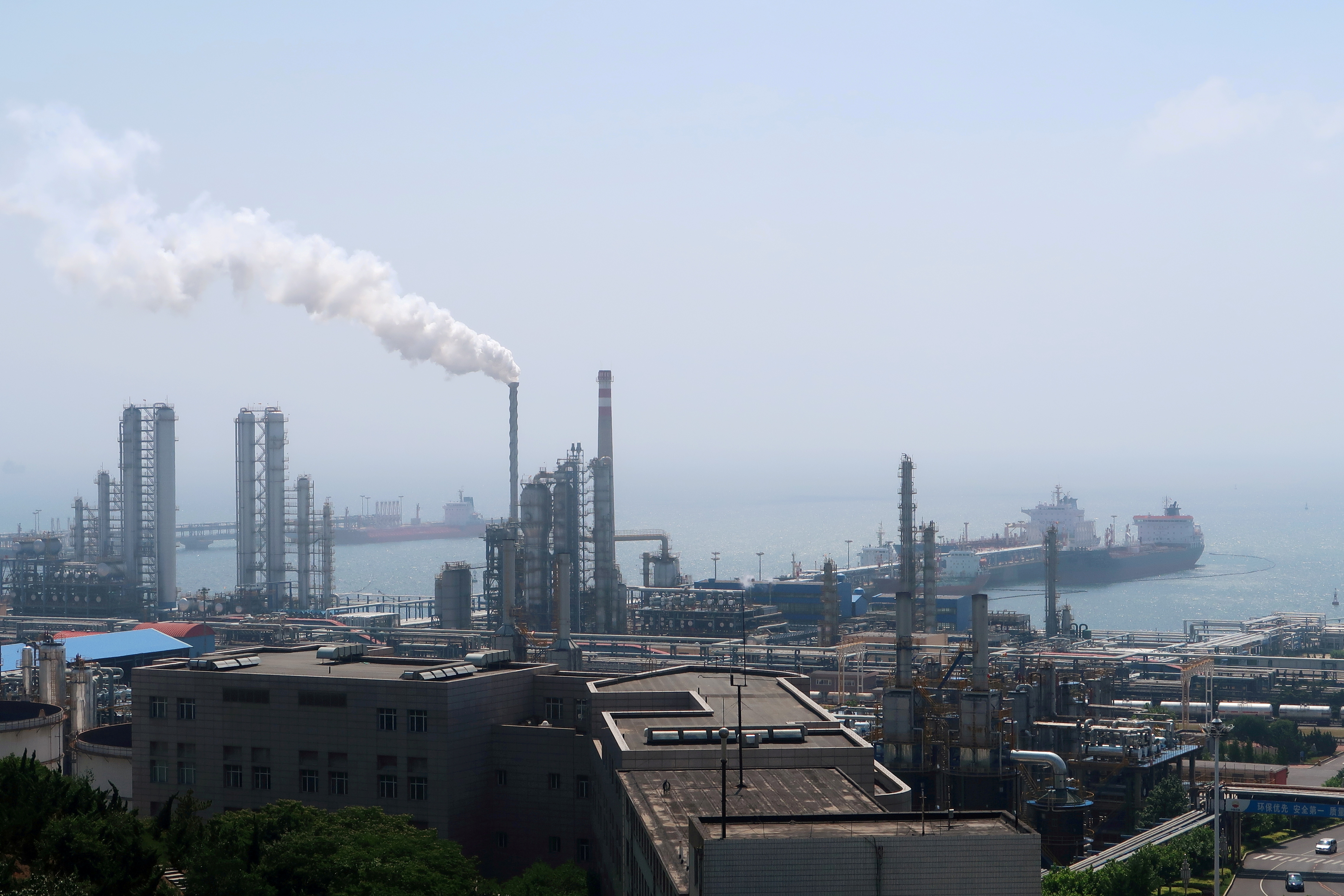 China National Petroleum Corporation (CNPC)'s Dalian Petrochemical Corp refinery is seen near the downtown of Dalian