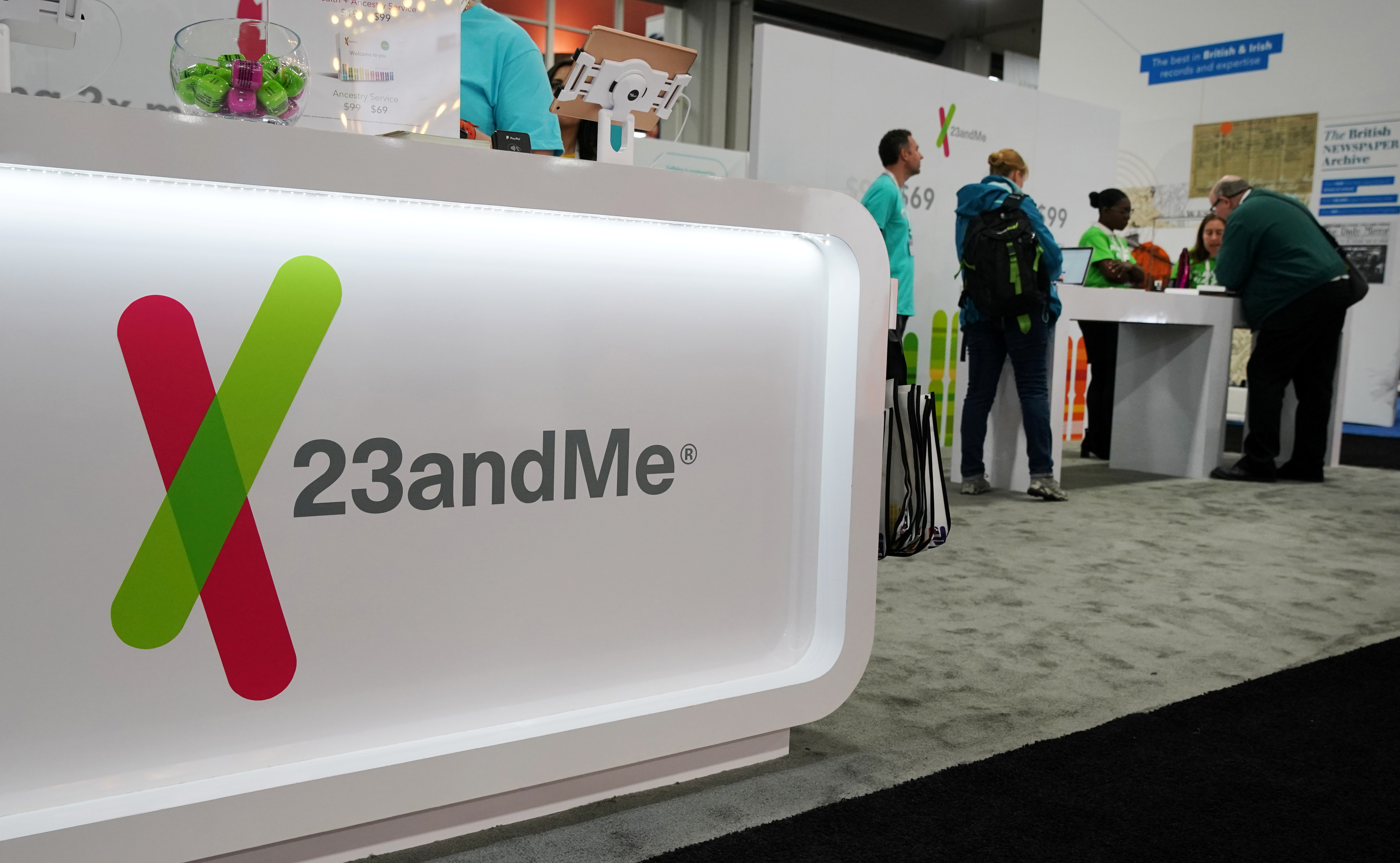 Attendees visit the 23andMe booth at the RootsTech annual genealogical event in Salt Lake City