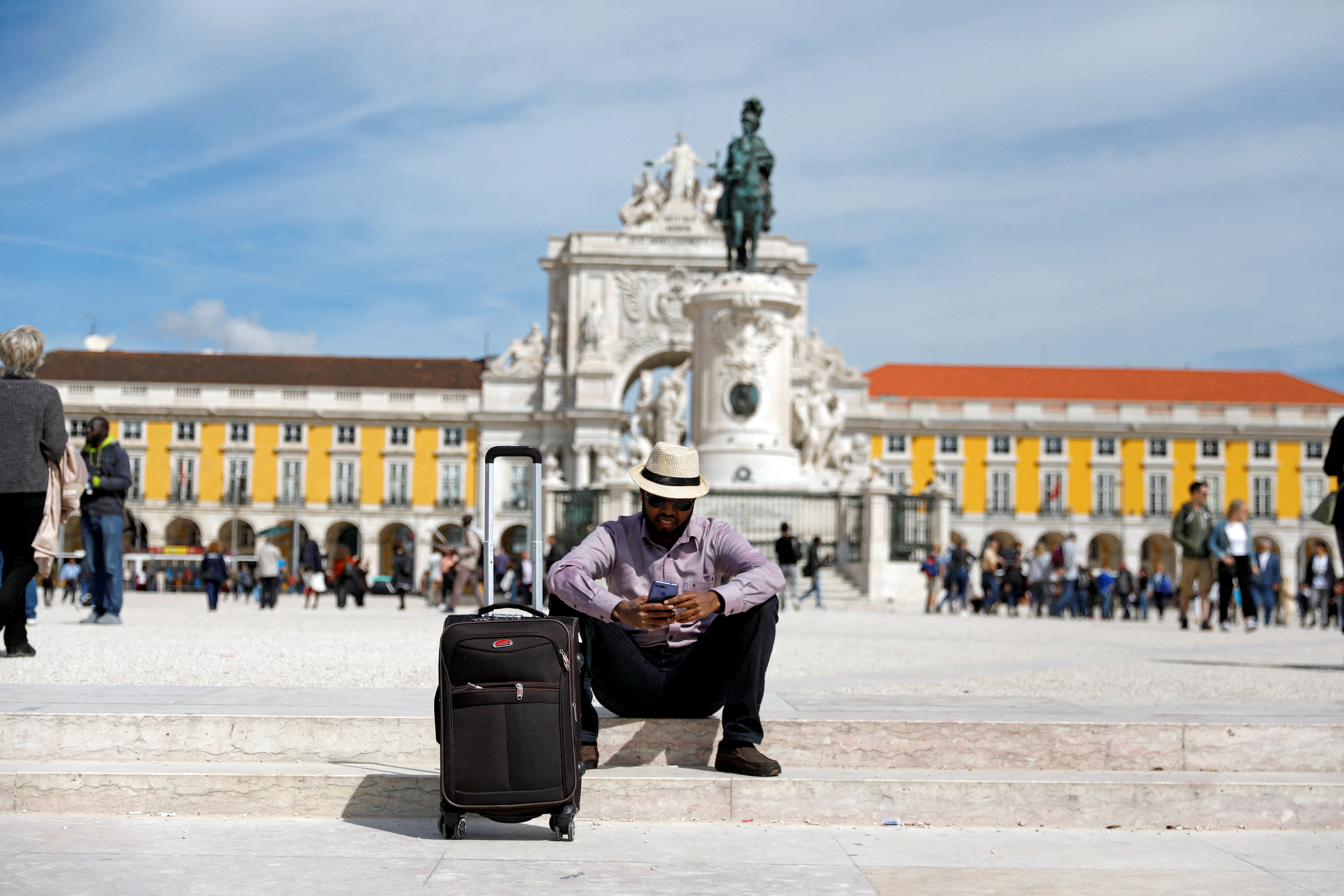 A tourist rests at Comercio square in downtown Lisbon