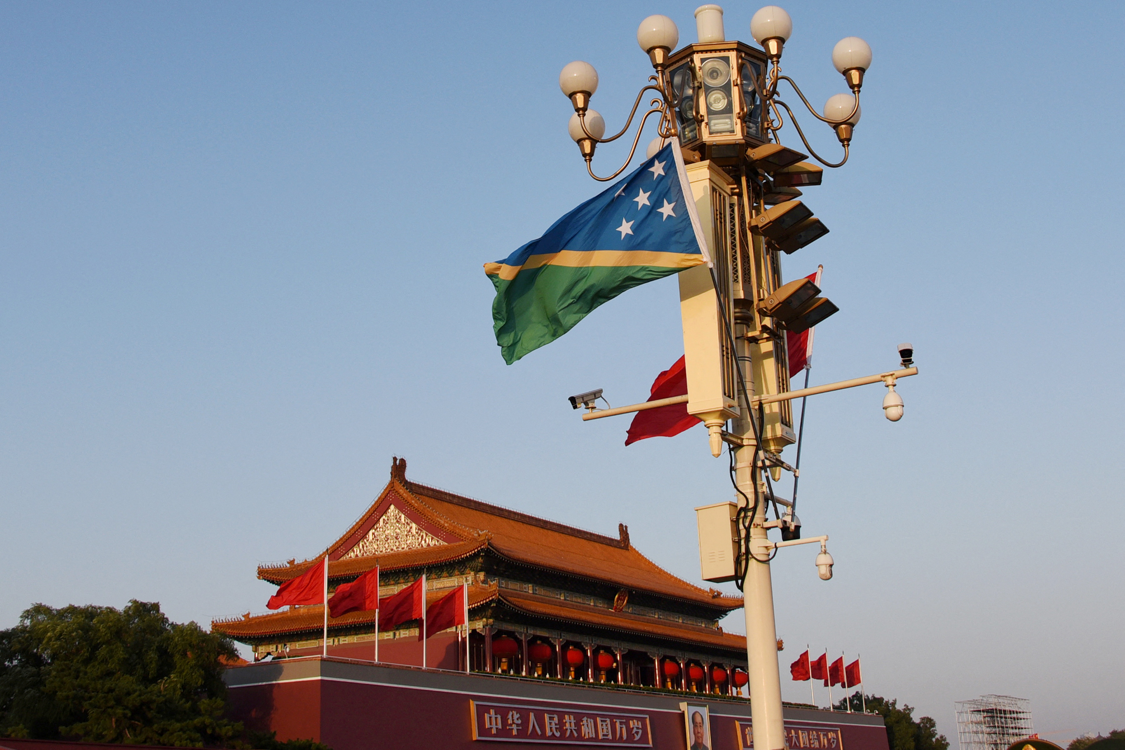 National flags of Solomon Islands and China flutter at the Tiananmen Square in Beijing