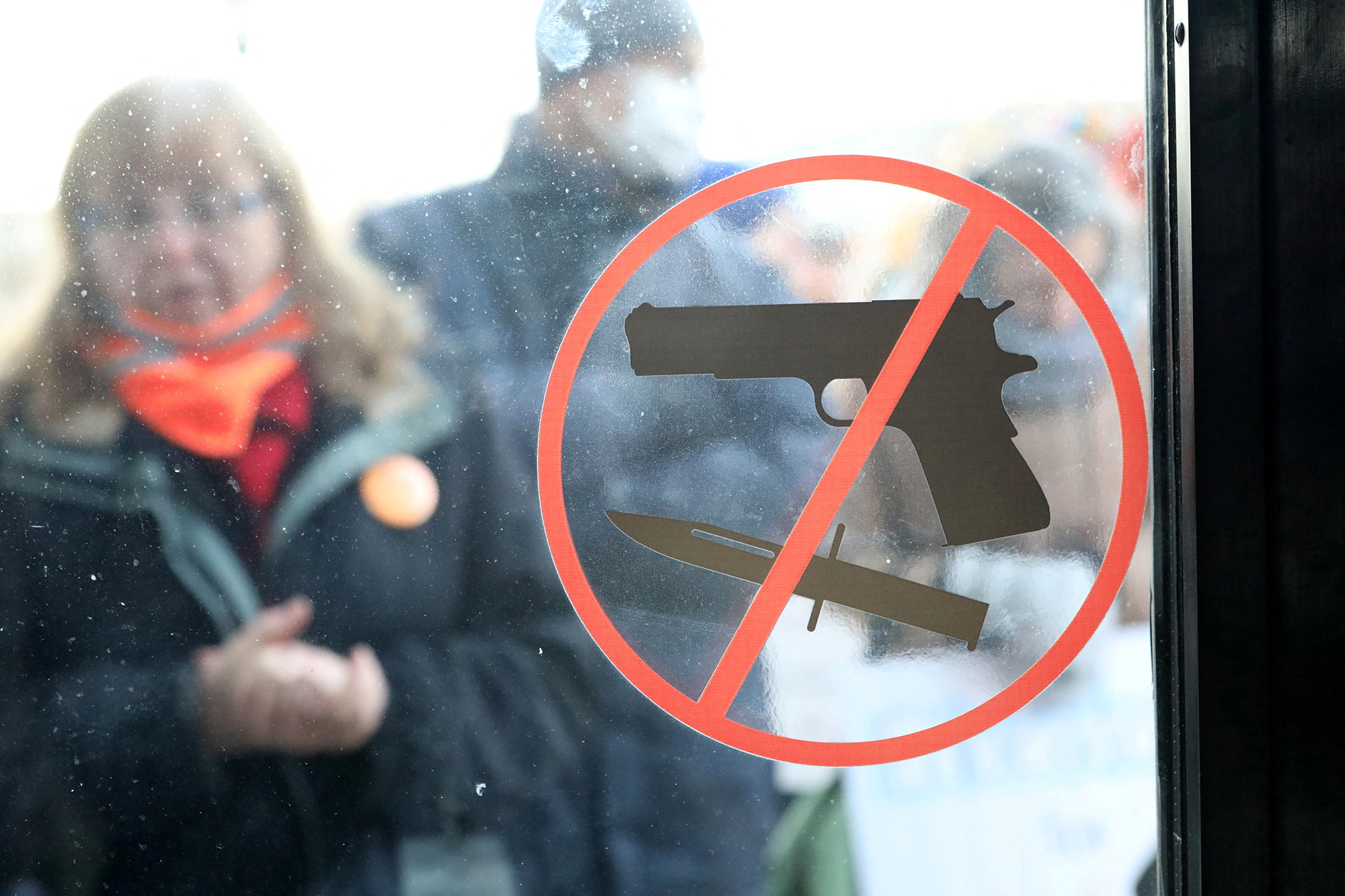 People gather in support of passing gun safety regulations, outside the Maine State House in Augusta, Maine
