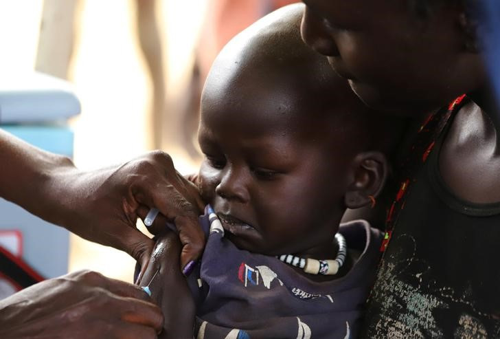 A South Sudanese child receives a vaccination against measles during a campaign in Juba