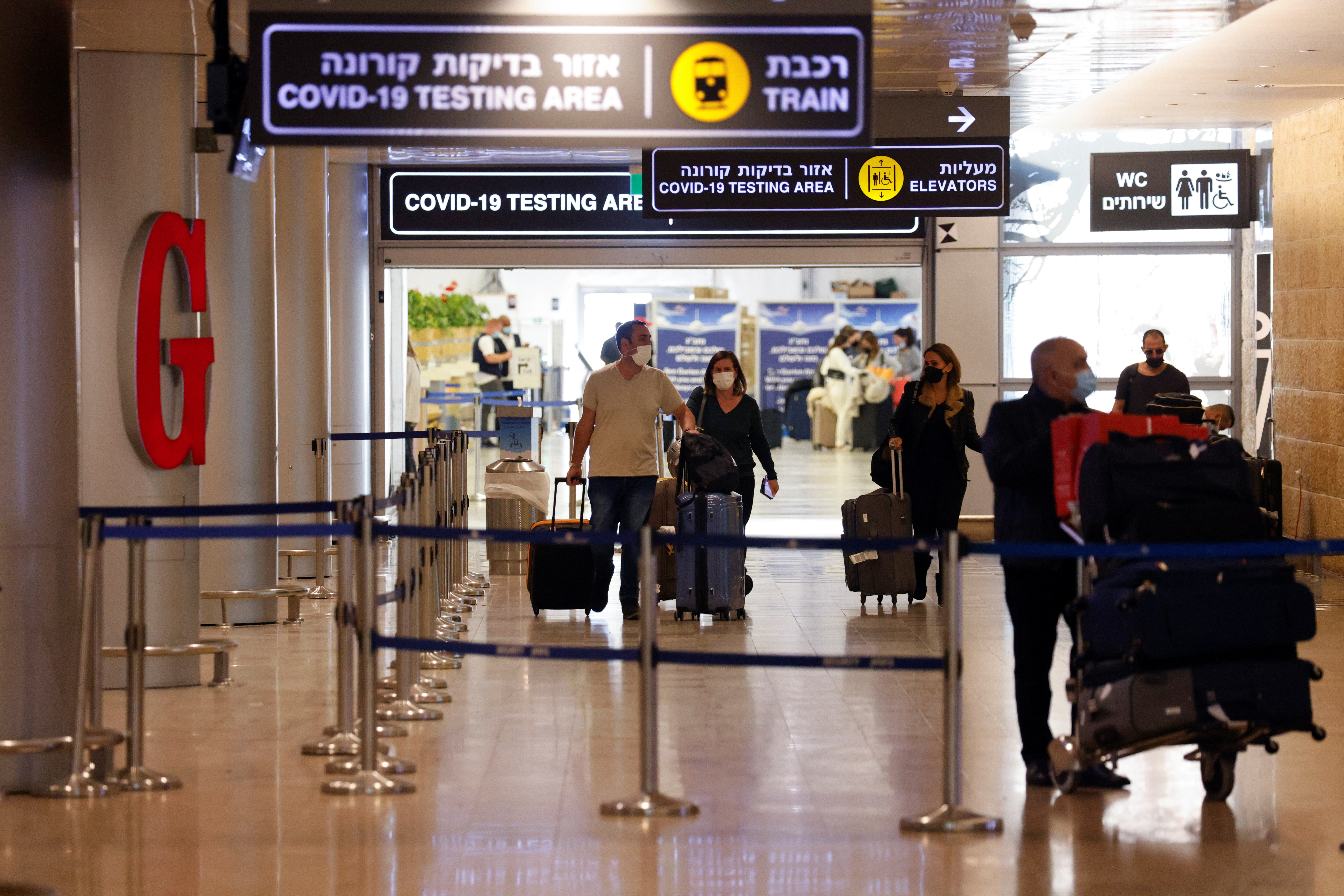 Travellers exit the coronavirus disease (COVID-19) pandemic testing area at Ben Gurion International Airport as Israel imposes new restrictions near Tel Aviv, Israel November 28, 2021. REUTERS/Amir Cohen