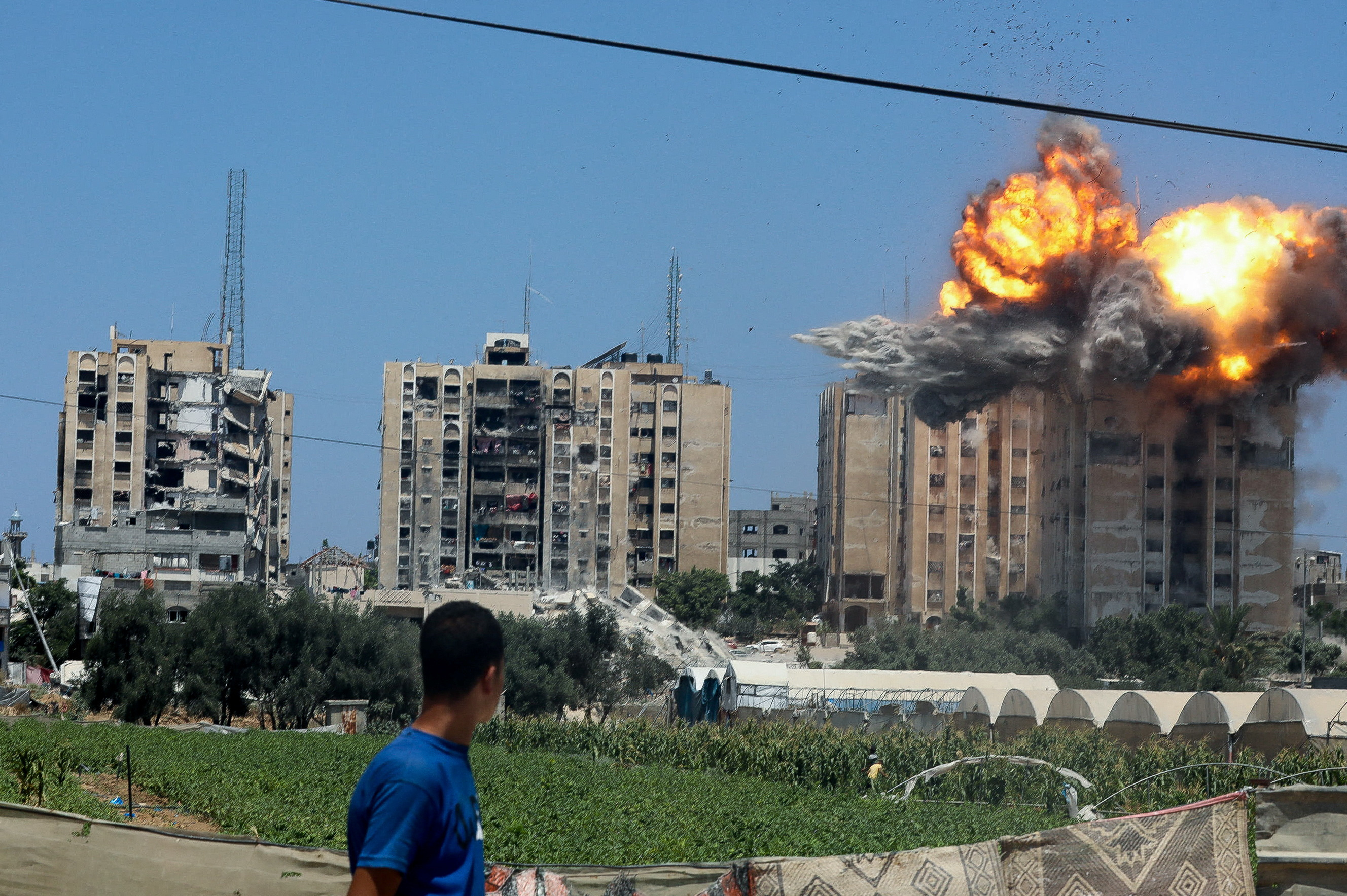 Explosion following an Israeli air strike on a residential building, amid the Israel-Hamas conflict, in Nuseirat