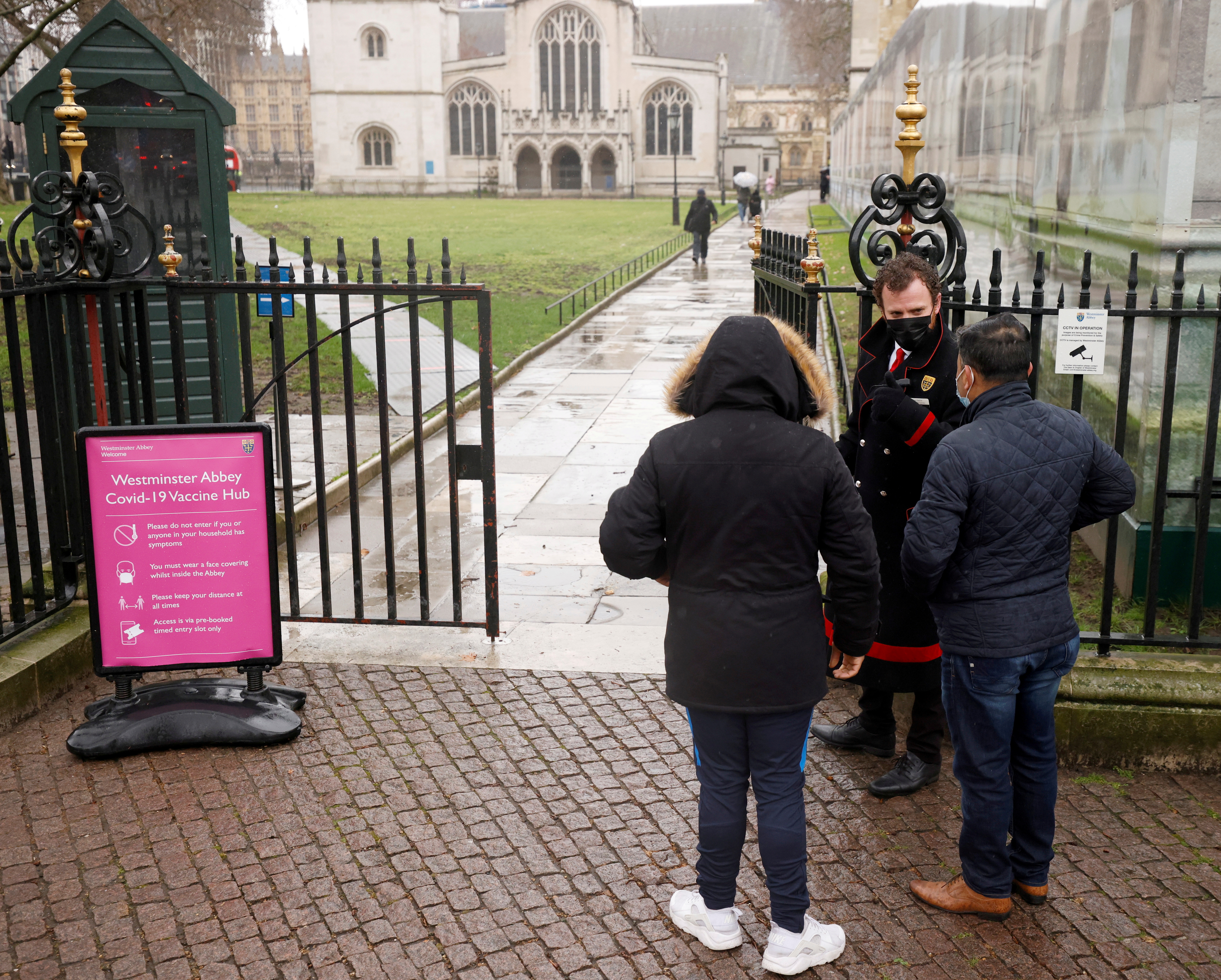 Patients are greeted by Abbey staff outside a vaccination centre at Westminster Abbey in London
