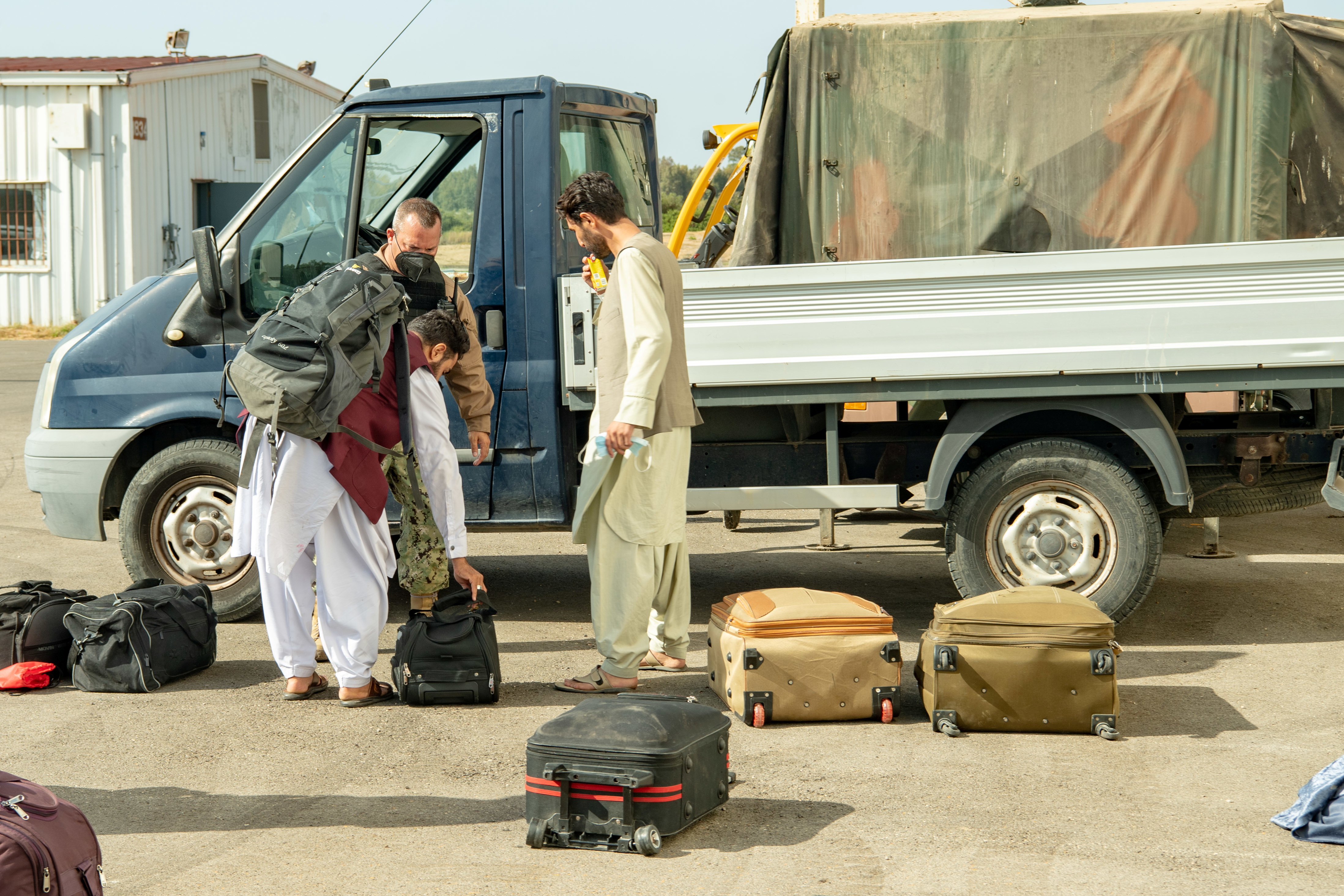 Afghan citizens who have been evacuated from Kabul arrive at Naval Station (NAVSTA) Rota Air Base