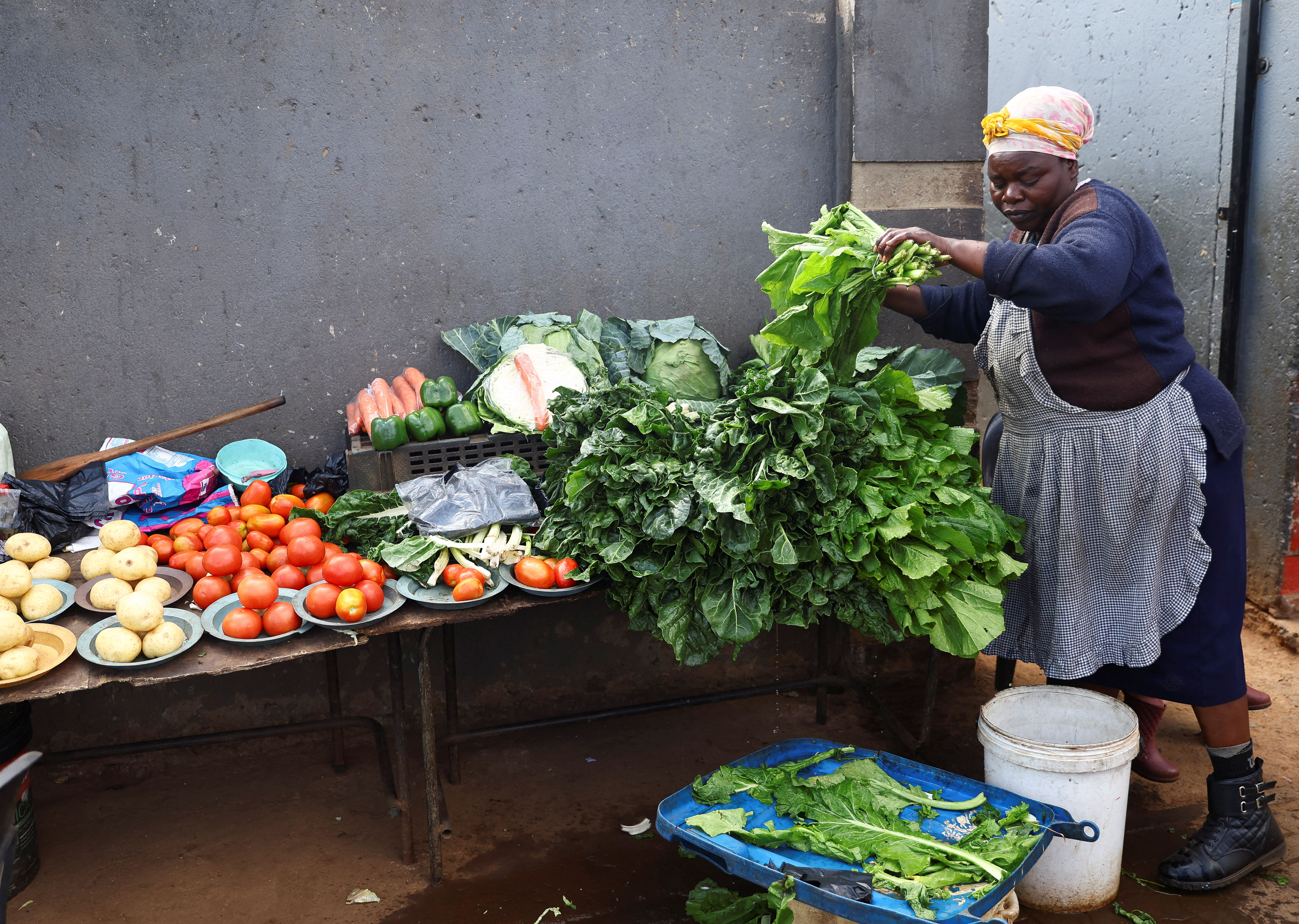 A woman prepares vegetables for customers