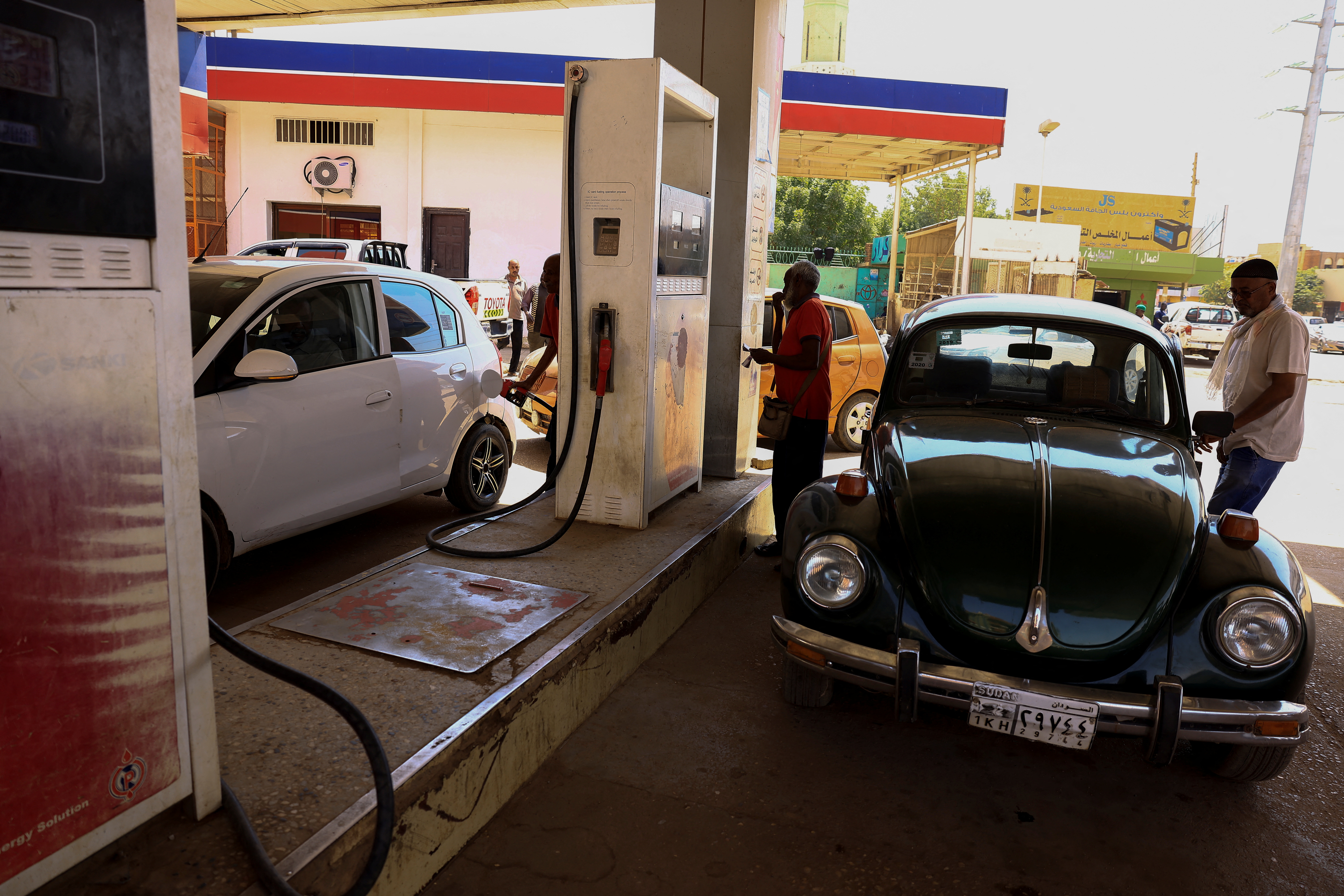 Cars are seen at fuel station in Khartoum