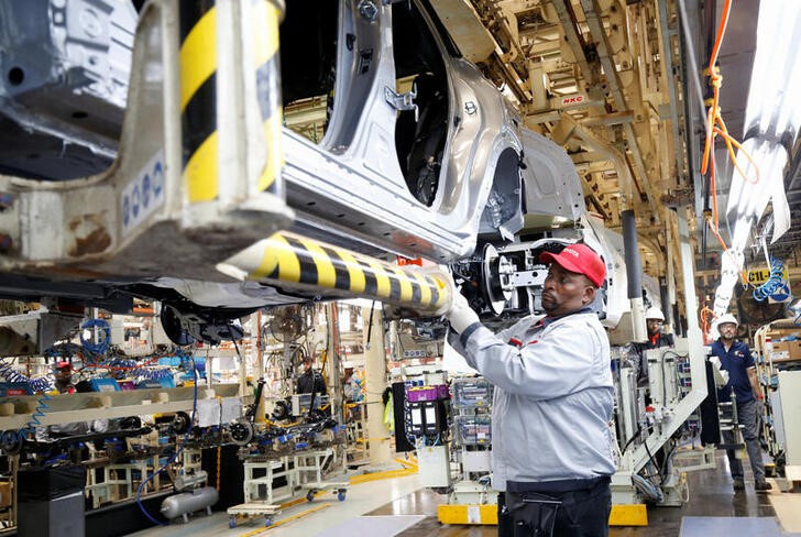 Workers assemble a vehicle as operations begin after flooding in April shut down the Toyota South Africa Motors plant, in Durban