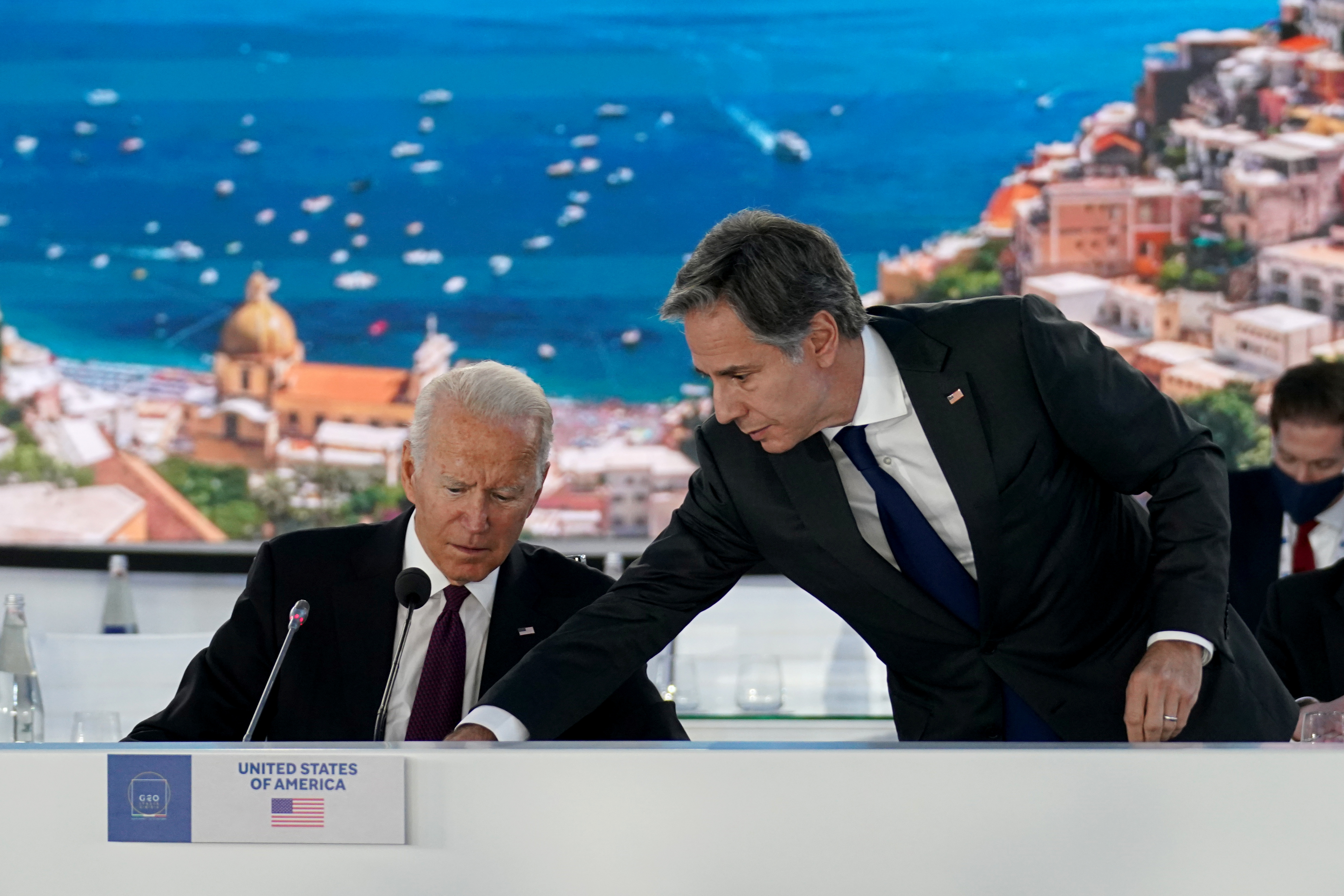U.S. Secretary of State Antony Blinken adjusts a microphone for U.S. President Joe Biden as he hosts an event on global supply chain resilience through the coronavirus disease (COVID-19) pandemic and recovery, on the sidelines of the G20 leaders' summit in Rome, Italy October 31, 2021. REUTERS/Kevin Lamarque
