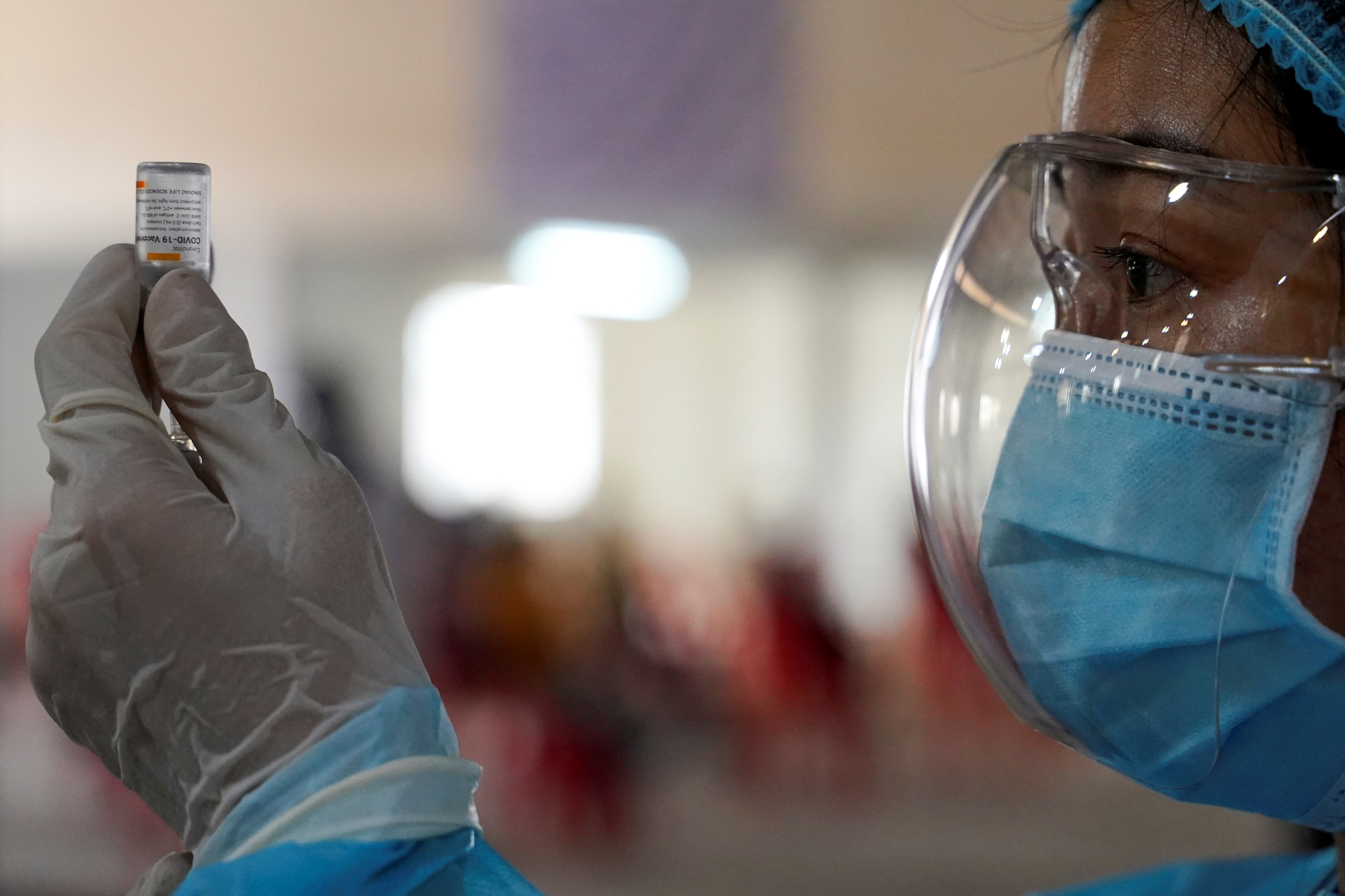 A nurse prepares a dose of China's Sinovac coronavirus disease (COVID-19) vaccine at an industrial park in Phnom Penh