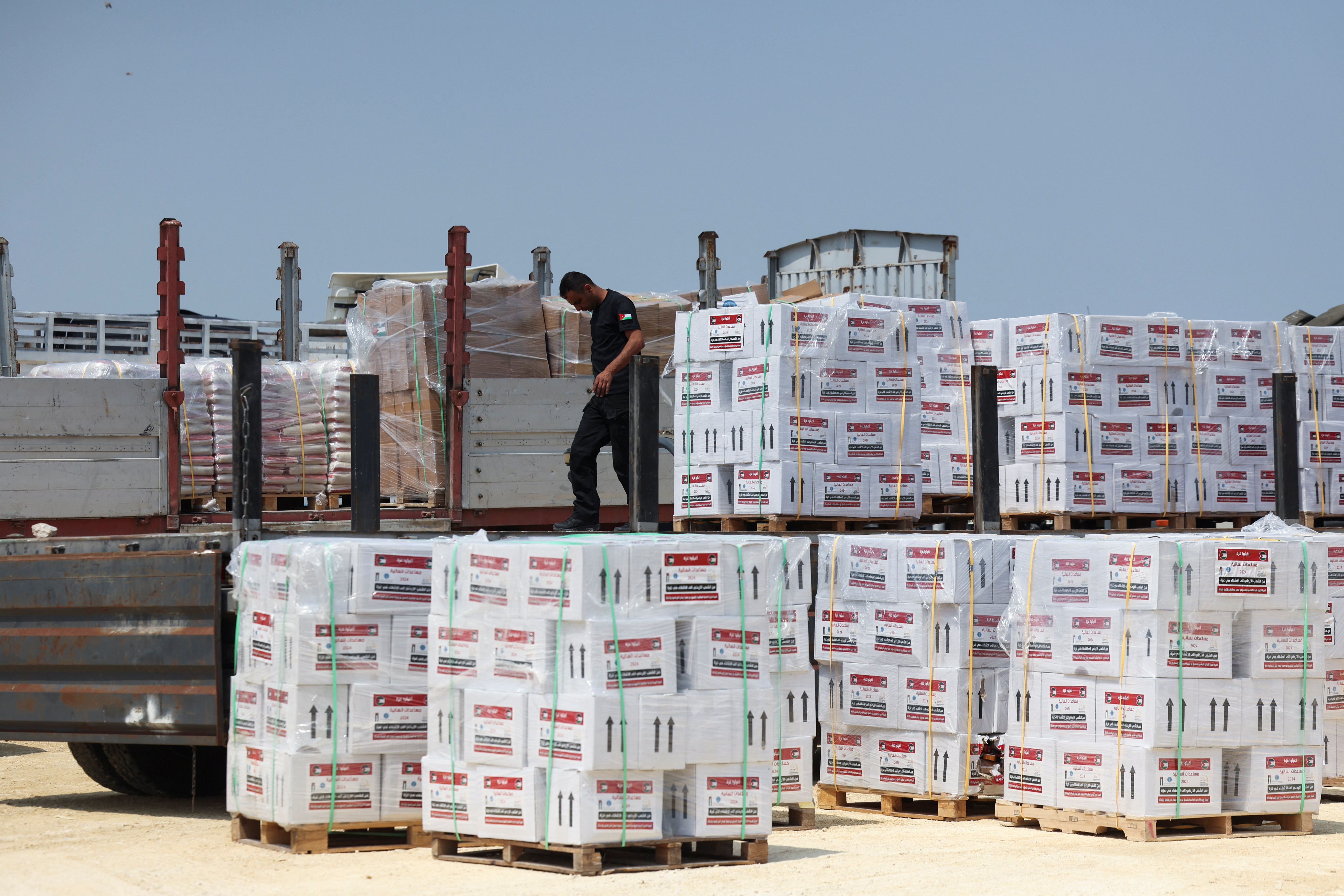 A worker unloads humanitarian aid near Erez Crossing in northern Gaza