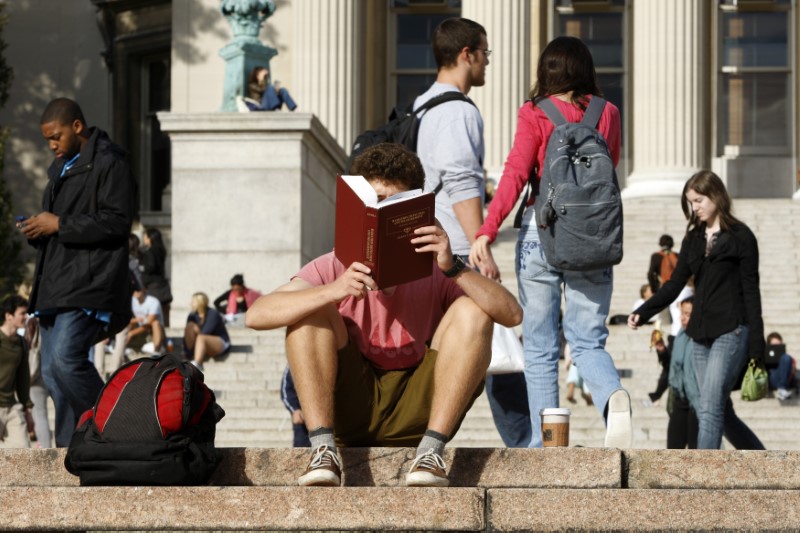 Student reads on the campus of Columbia University in New York