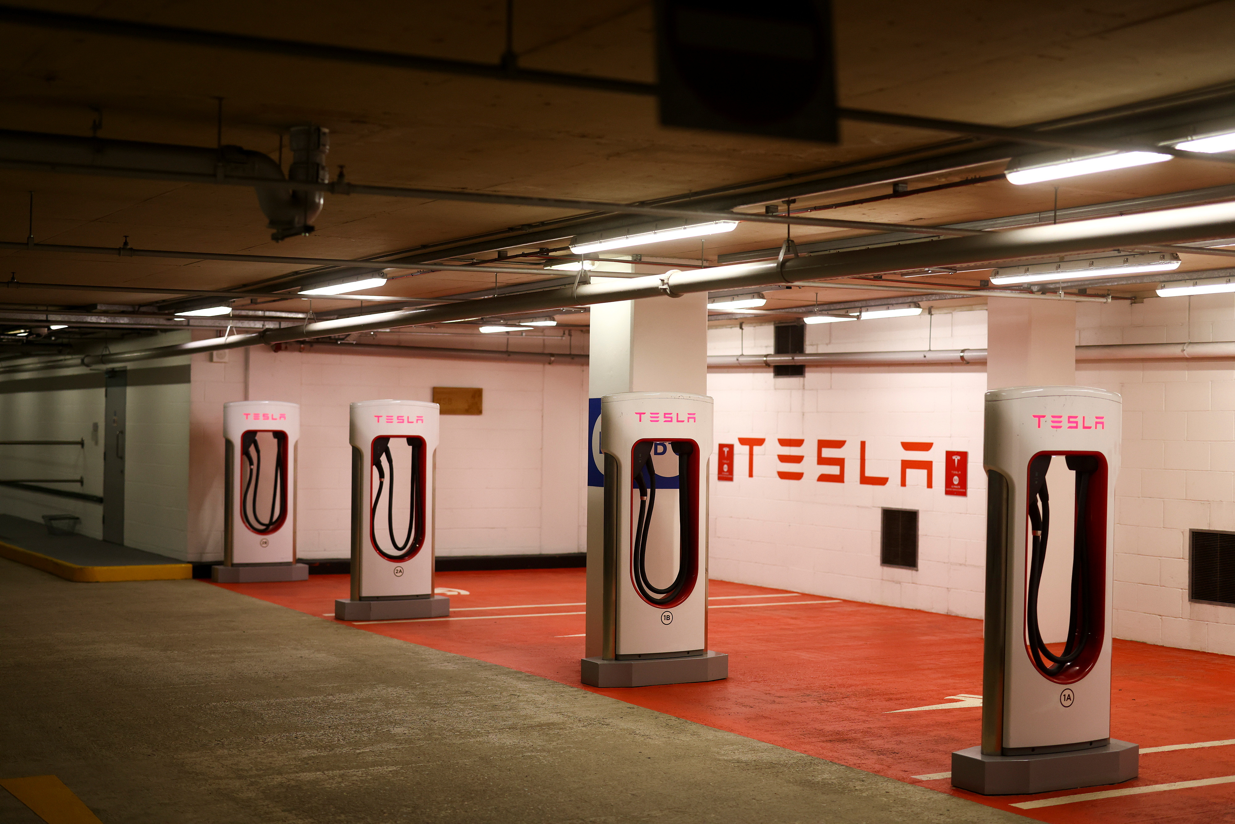 A Tesla electric charging point stands unused in a car park, as Britain will ban the sale of new petrol and diesel cars and vans from 2030, five years earlier than previously planned, in London
