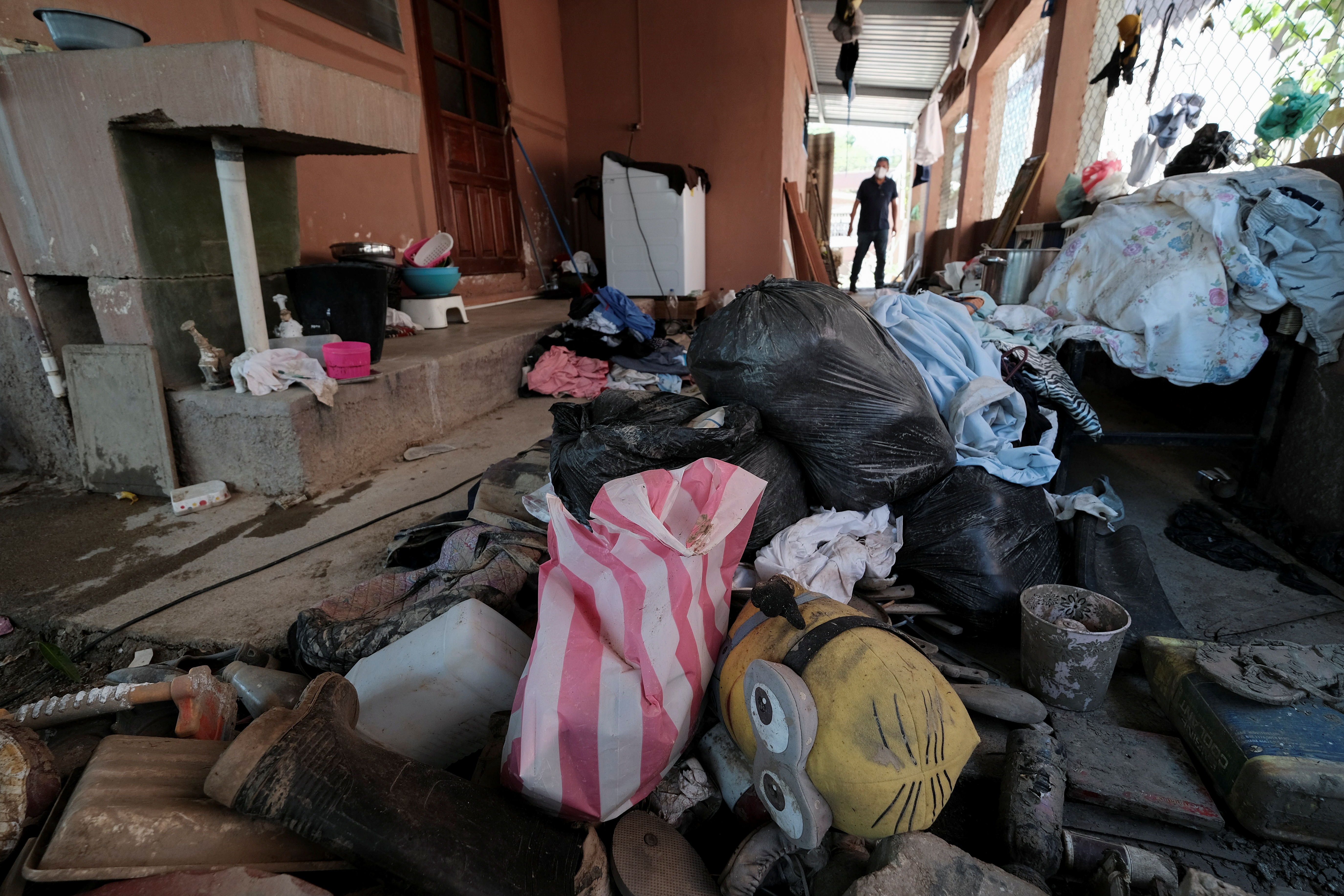 Plastic bags containing clothing are pictured at a house damaged by the floods caused by the hurricanes Eta and Iota at her house, in La Lima