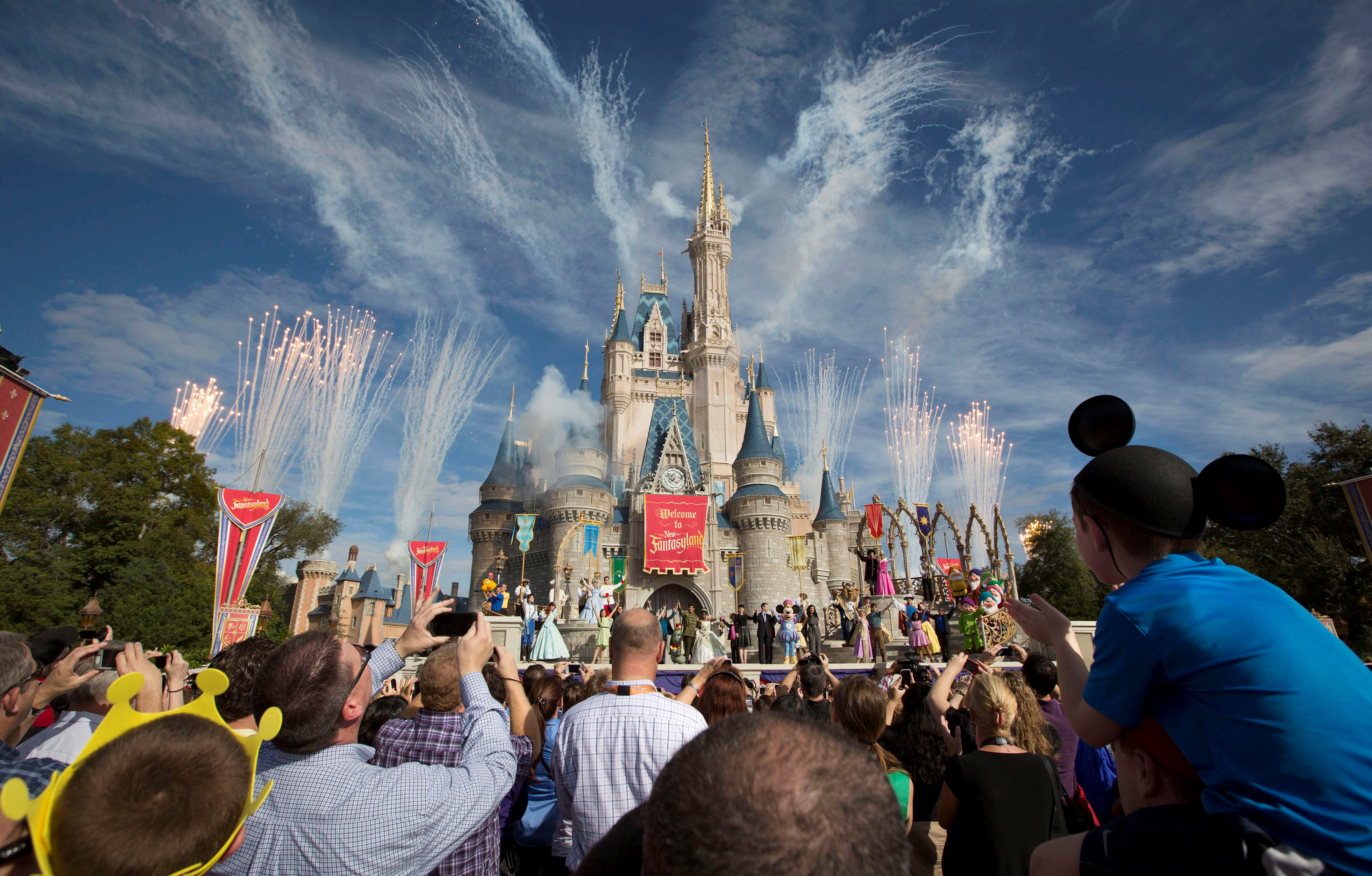Fireworks go off around Cinderella's castle during the grand opening ceremony for Walt Disney World's Fantasyland in Lake Buena Vista, Florida