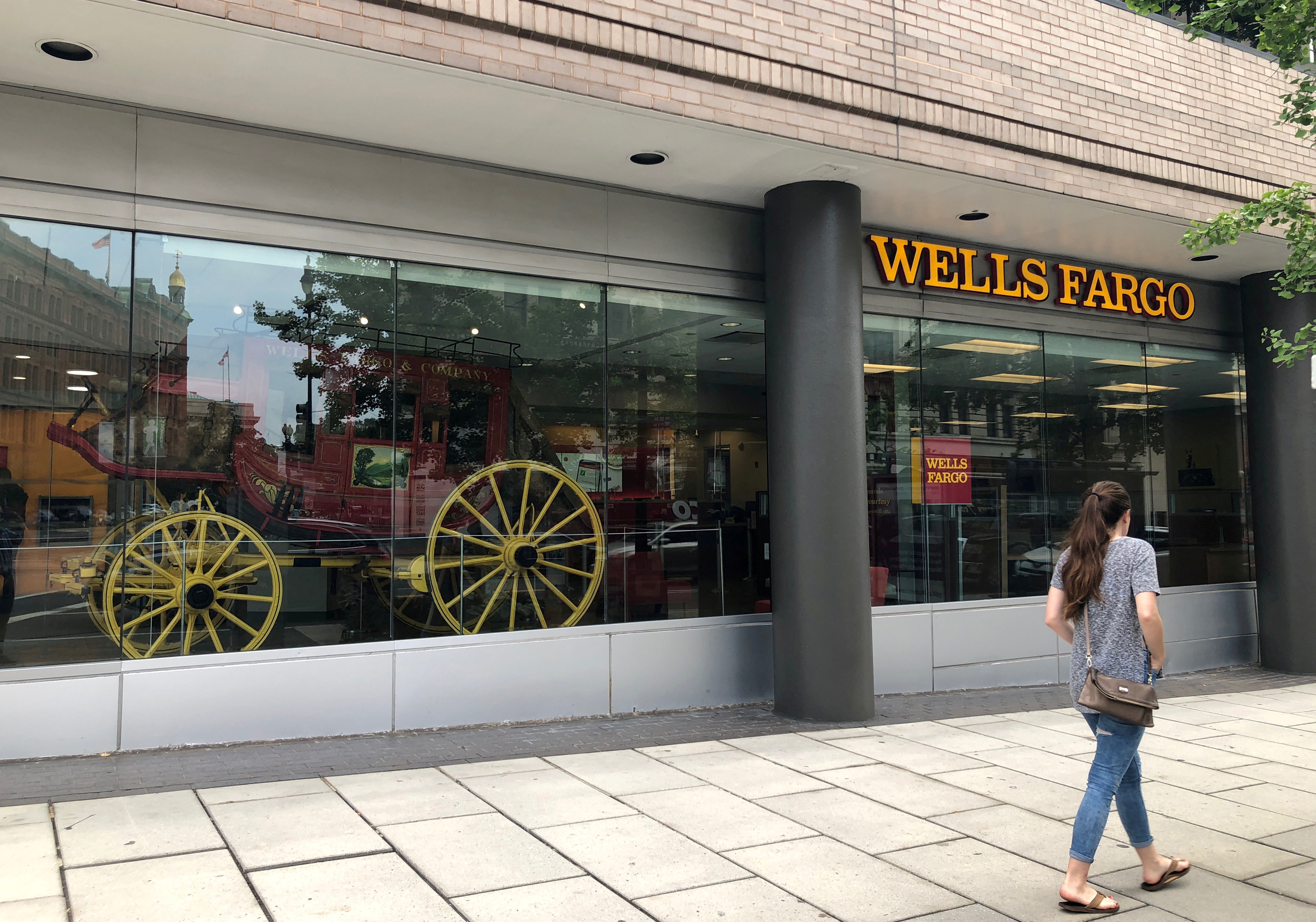 A lady walks by a Wells Fargo bank branch in Washington