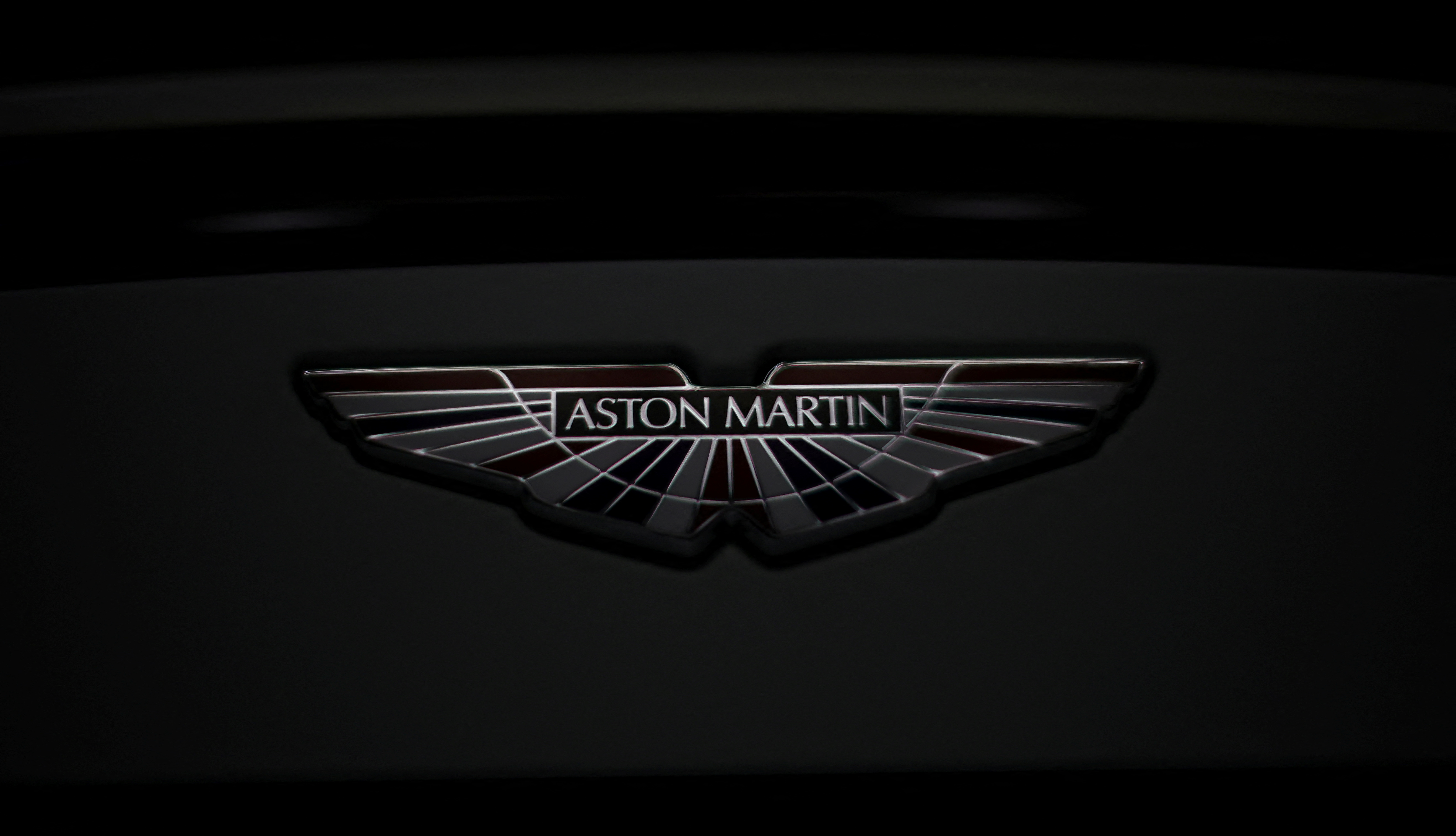 The Aston Martin logo is seen on a V12 Vantage car at the company’s factory in Gaydon
