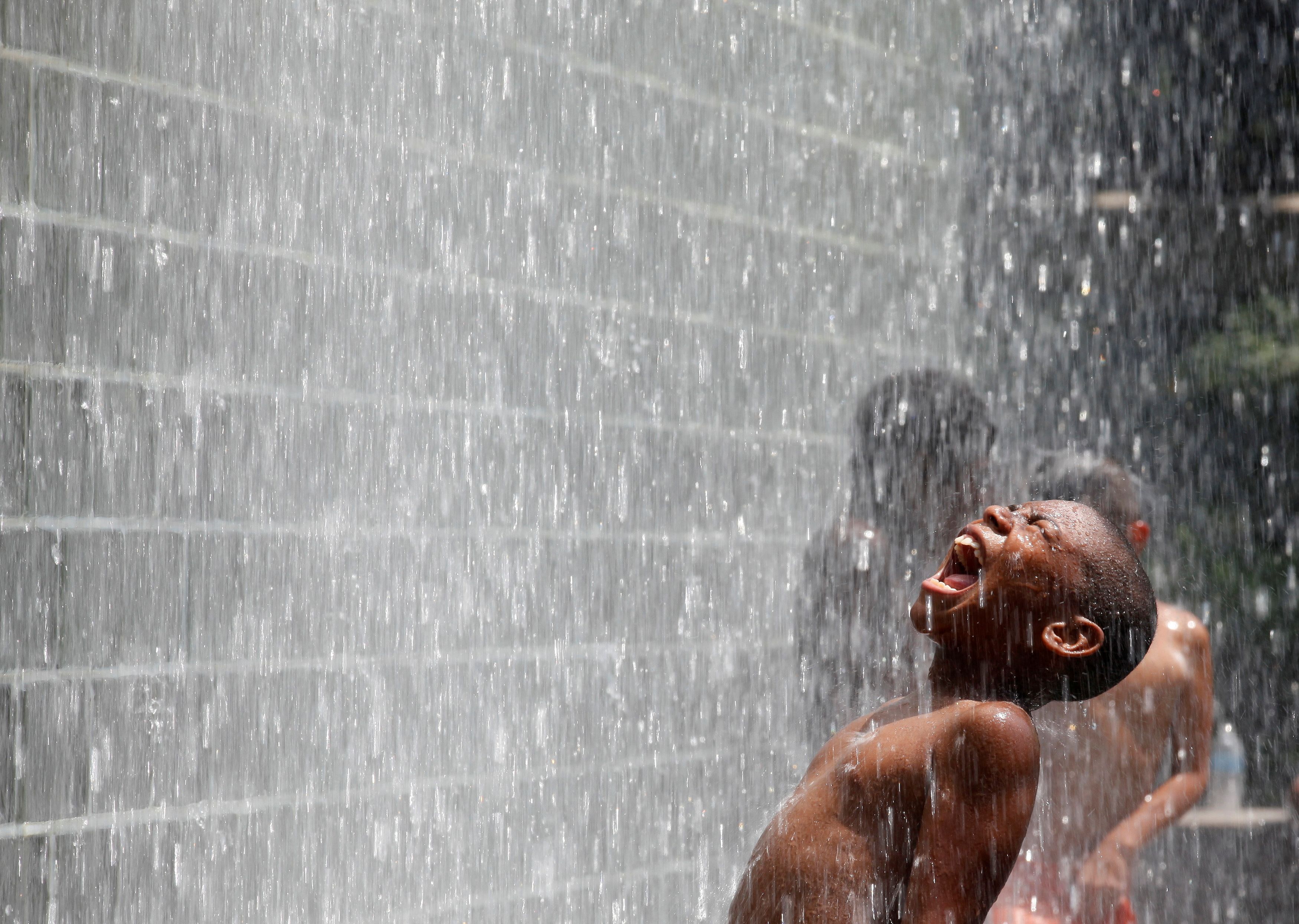 A boy cools off at the Crown Fountain at Millennium Park in Chicago