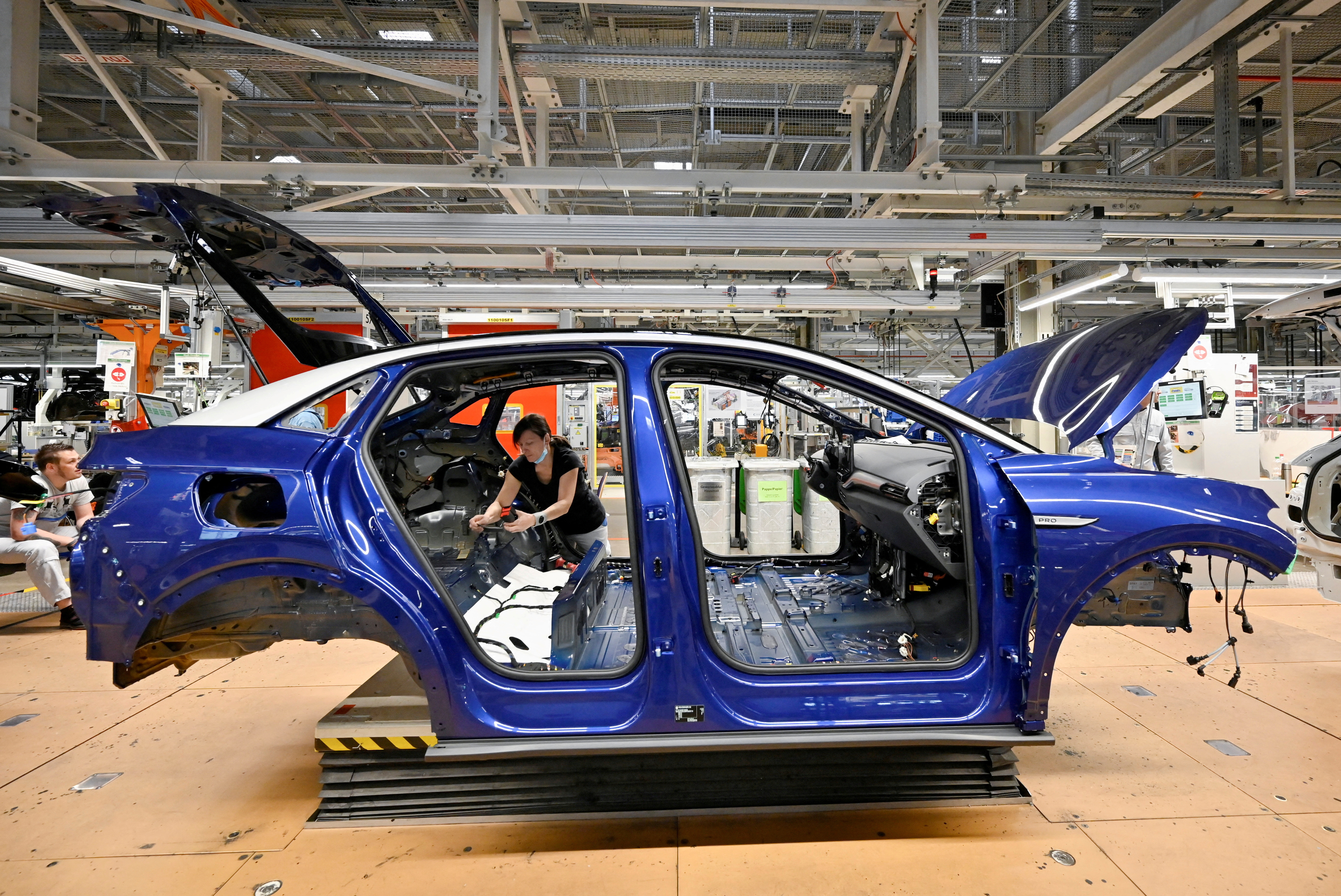 A technician works on a model of Volkswagen ID.4 at the carmaker's plant in Zwickau, Germany