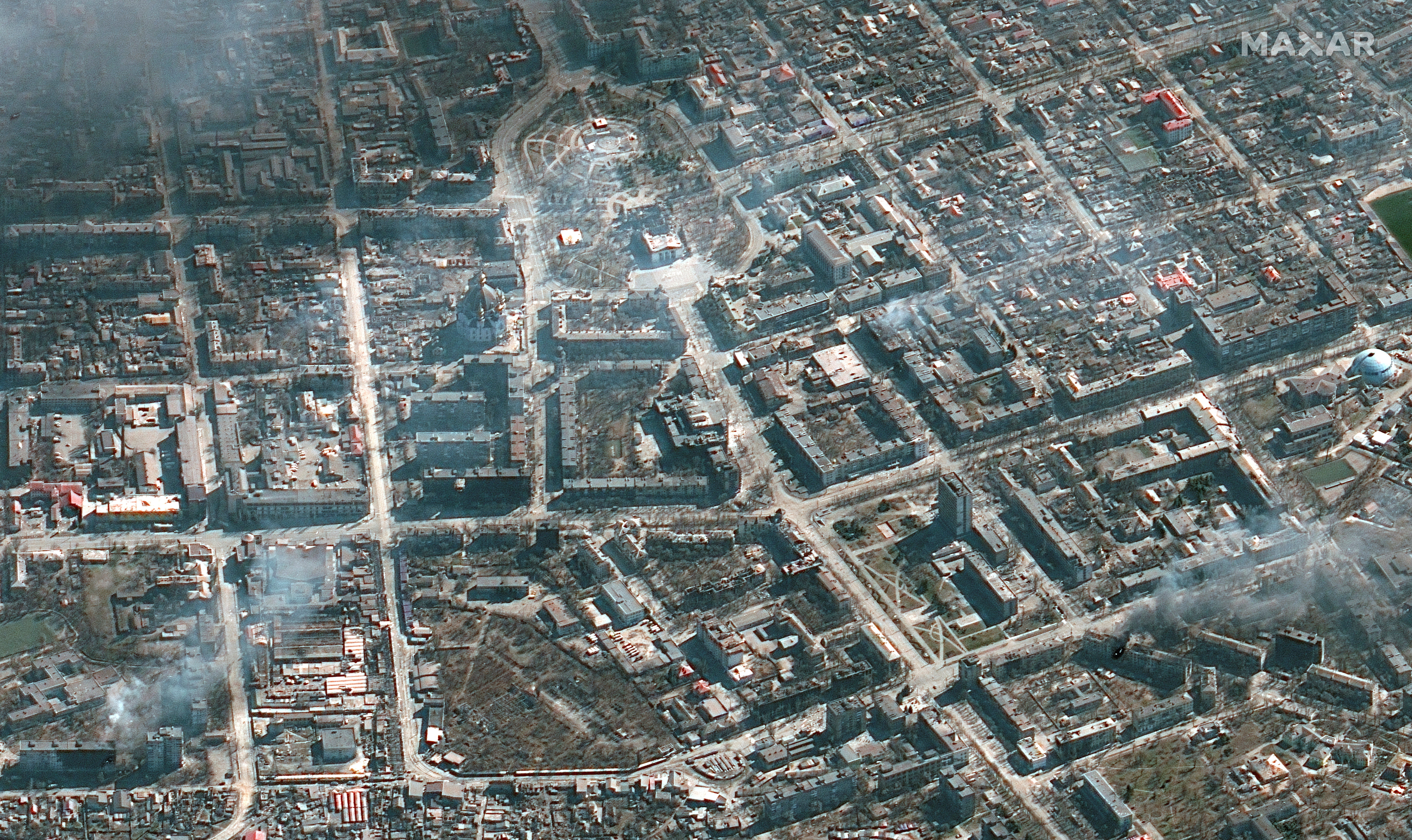A satellite image shows an overview of Mariupol burning building and Mariupol Theater