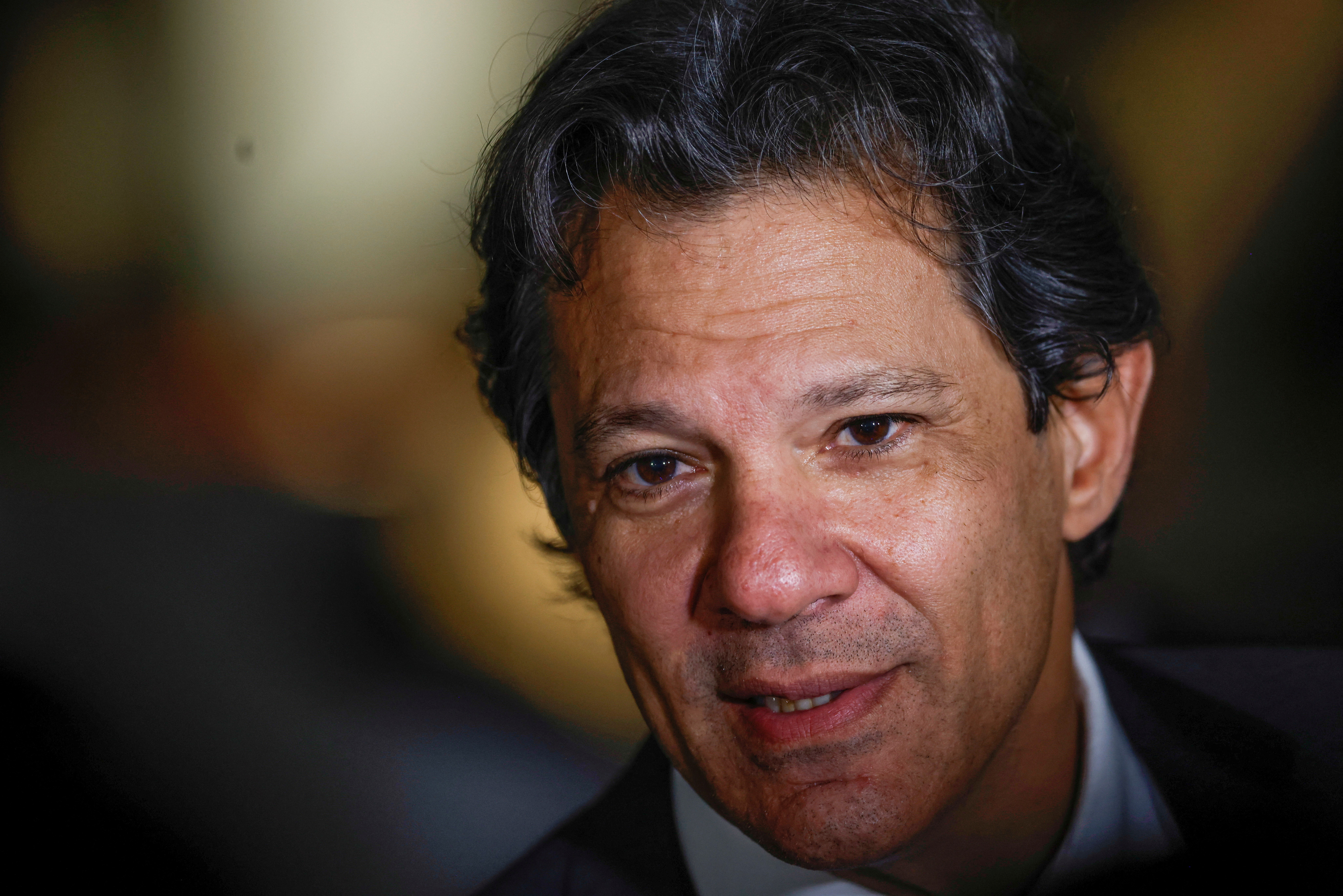 Former Mayor Fernando Haddad talks with journalists after attending a meeting at the transition government building in Brasilia