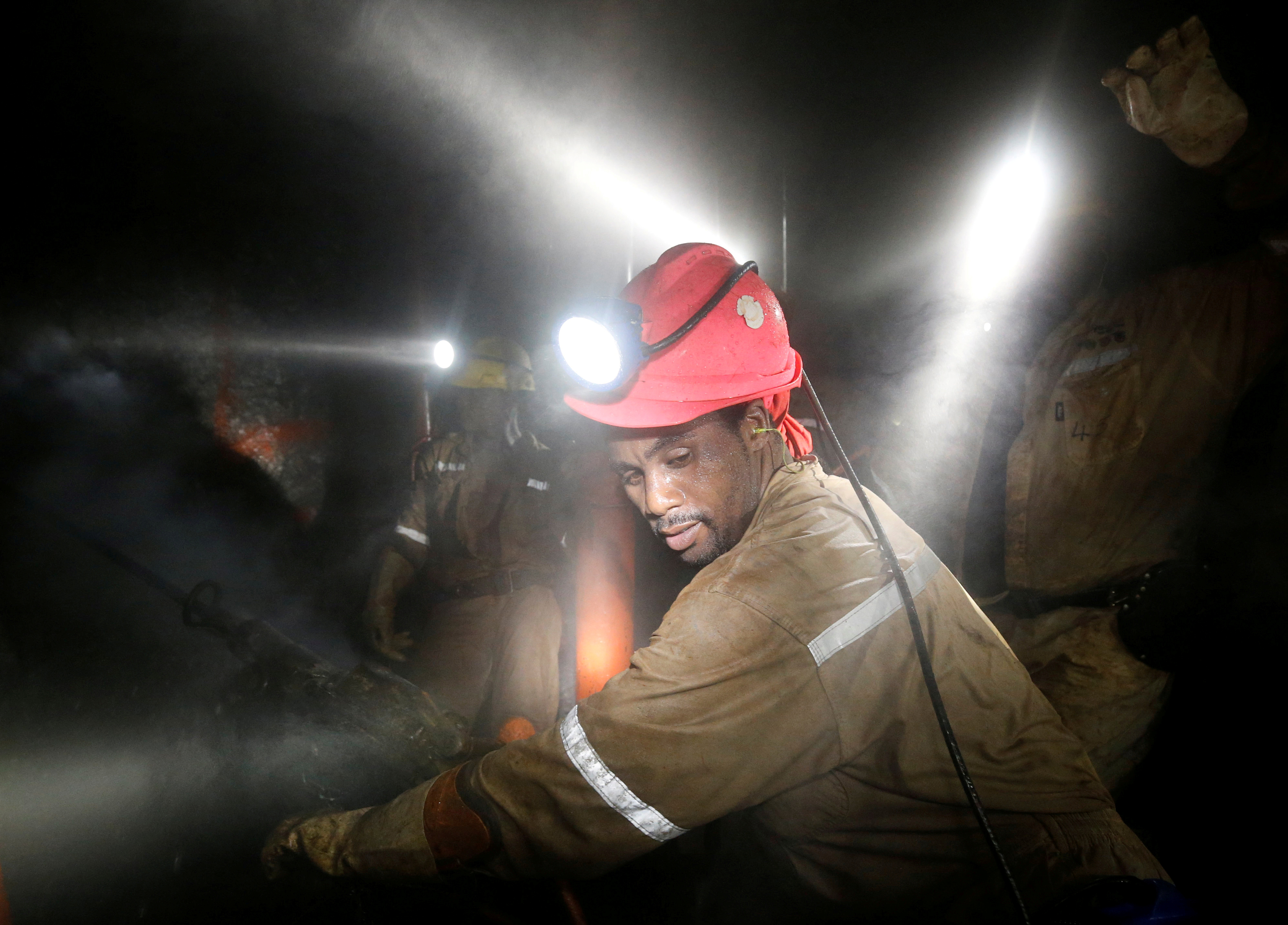 Miners work deep underground at Sibanye Gold's Masimthembe shaft in Westonaria