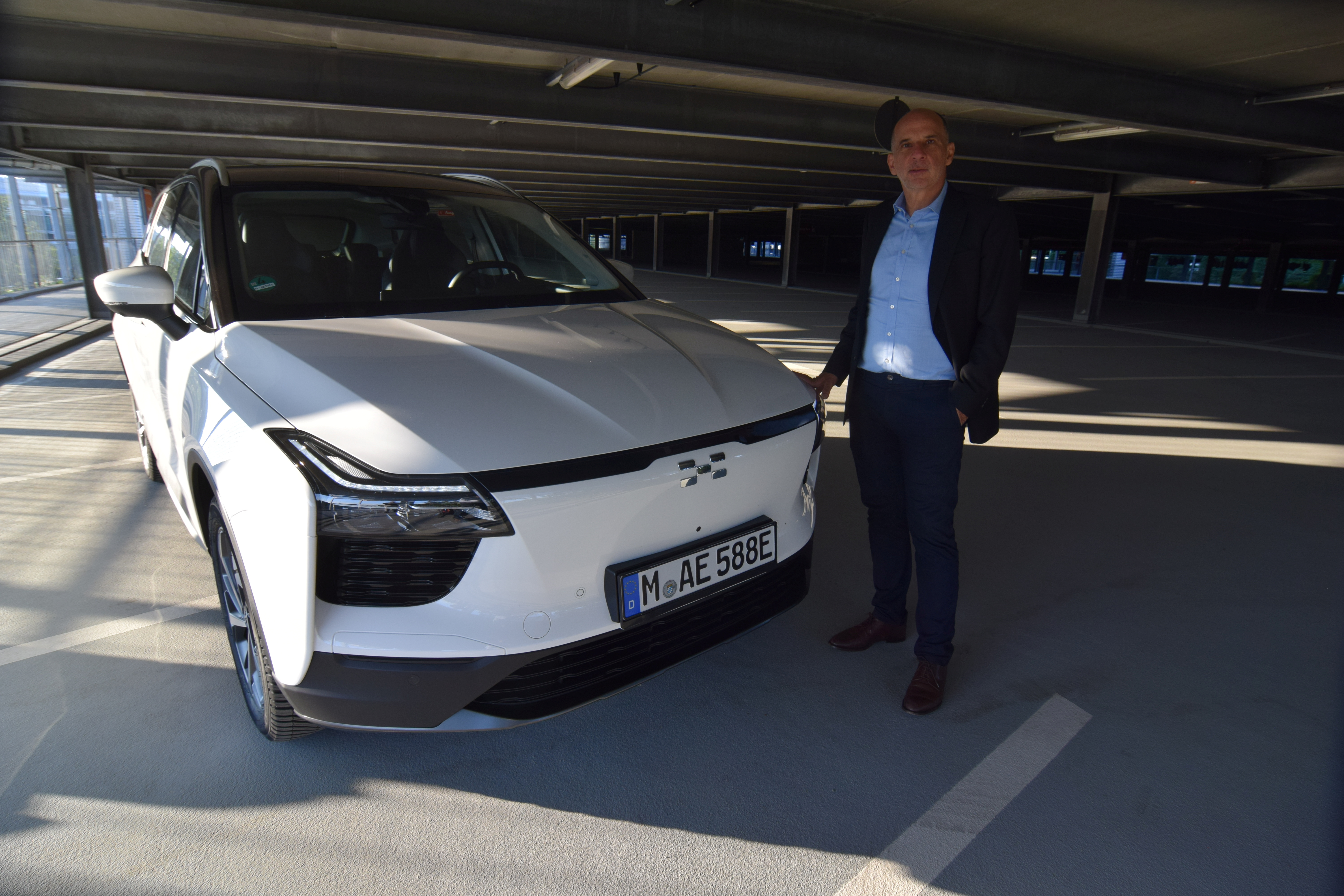 Aiways Executive Vice President Alexander Klose shows off the Chinese carmaker's electric U5 crossover SUV model, in Munich