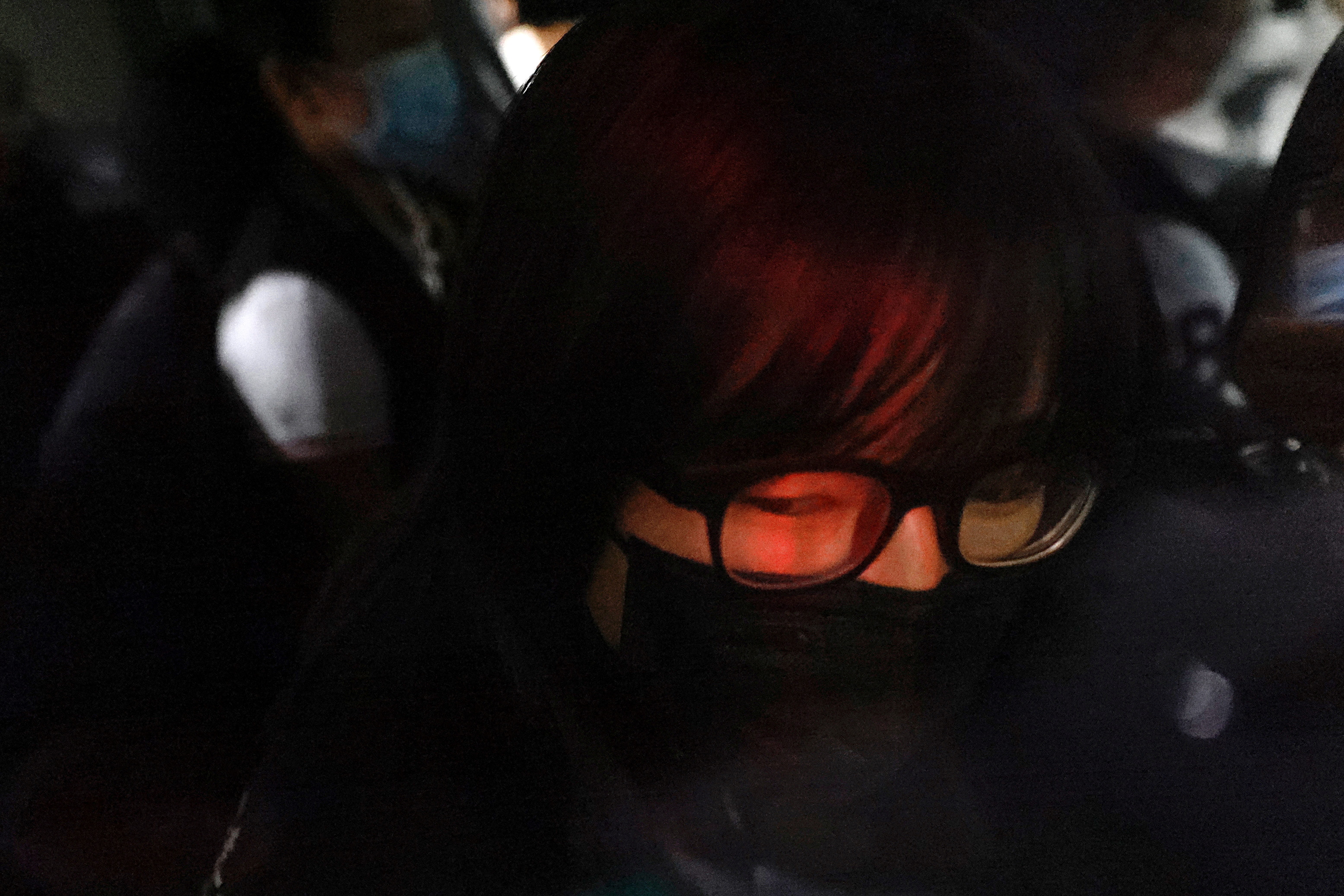 Hong Kong Alliance in Support of Patriotic Democratic Movements of China Vice-Chairwoman Tonyee Chow Hang-tung is seen inside a vehicle after being detained in Hong Kong, China, September 8, 2021. REUTERS/Tyrone Siu