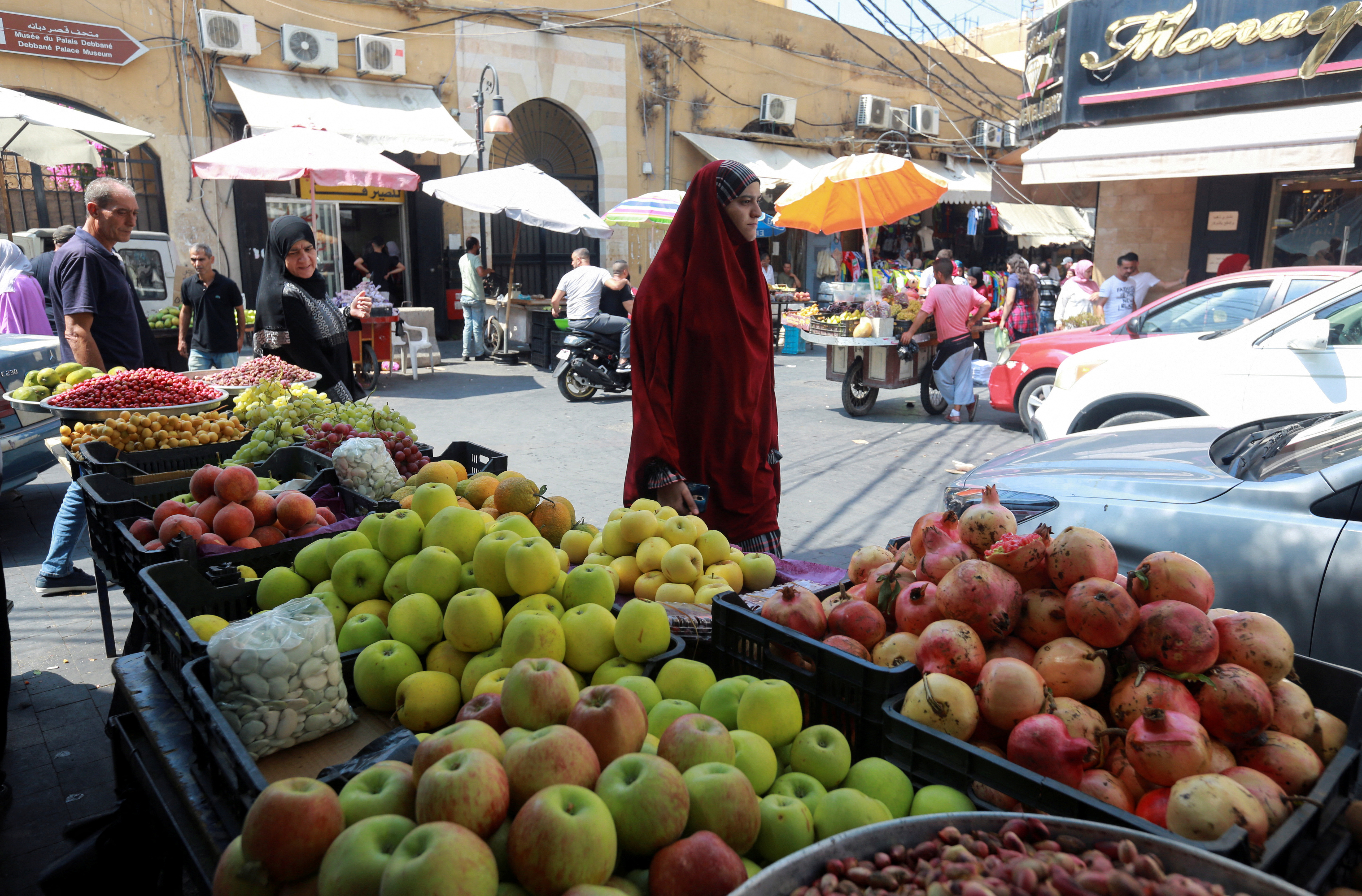A woman walks at a market in the southern Lebanese city of Sidon