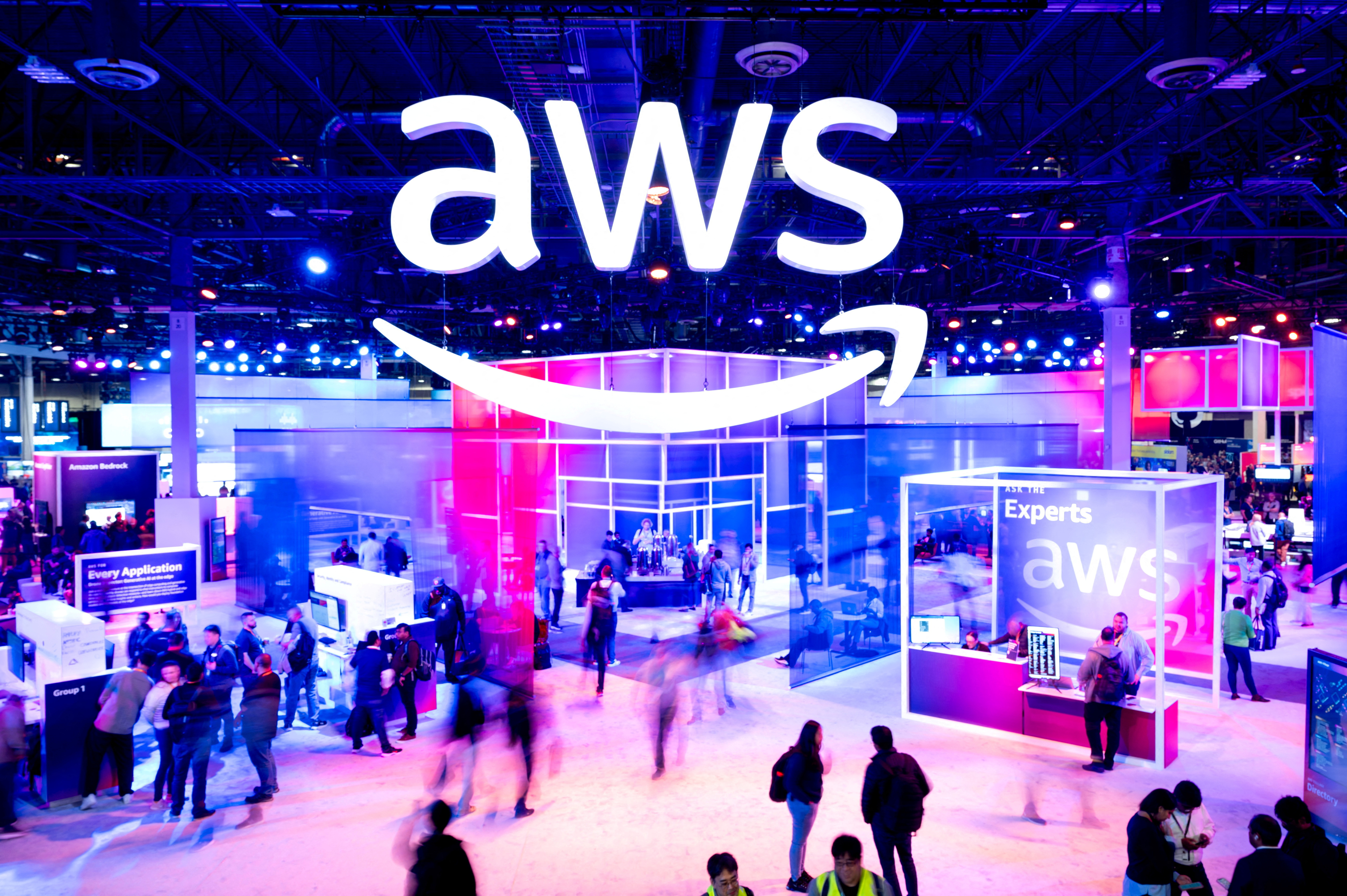 Attendees walk through an expo hall at AWS re:Invent 2023, a conference hosted by Amazon Web Services (AWS), in Las Vegas