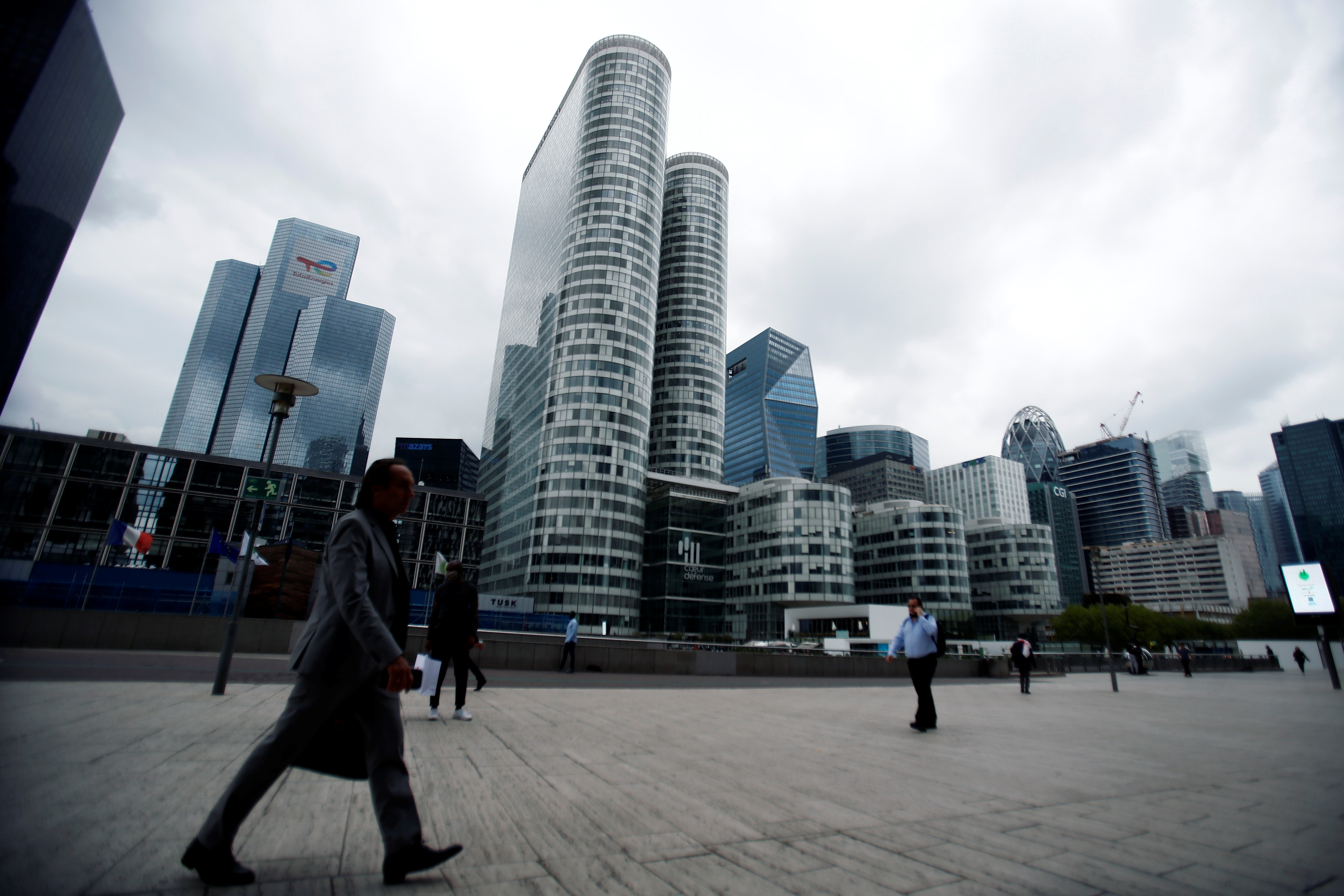 People walk through the financial and business district of La Defense in Puteaux near Paris, France, August 23, 2021. REUTERS/Sarah Meyssonnier