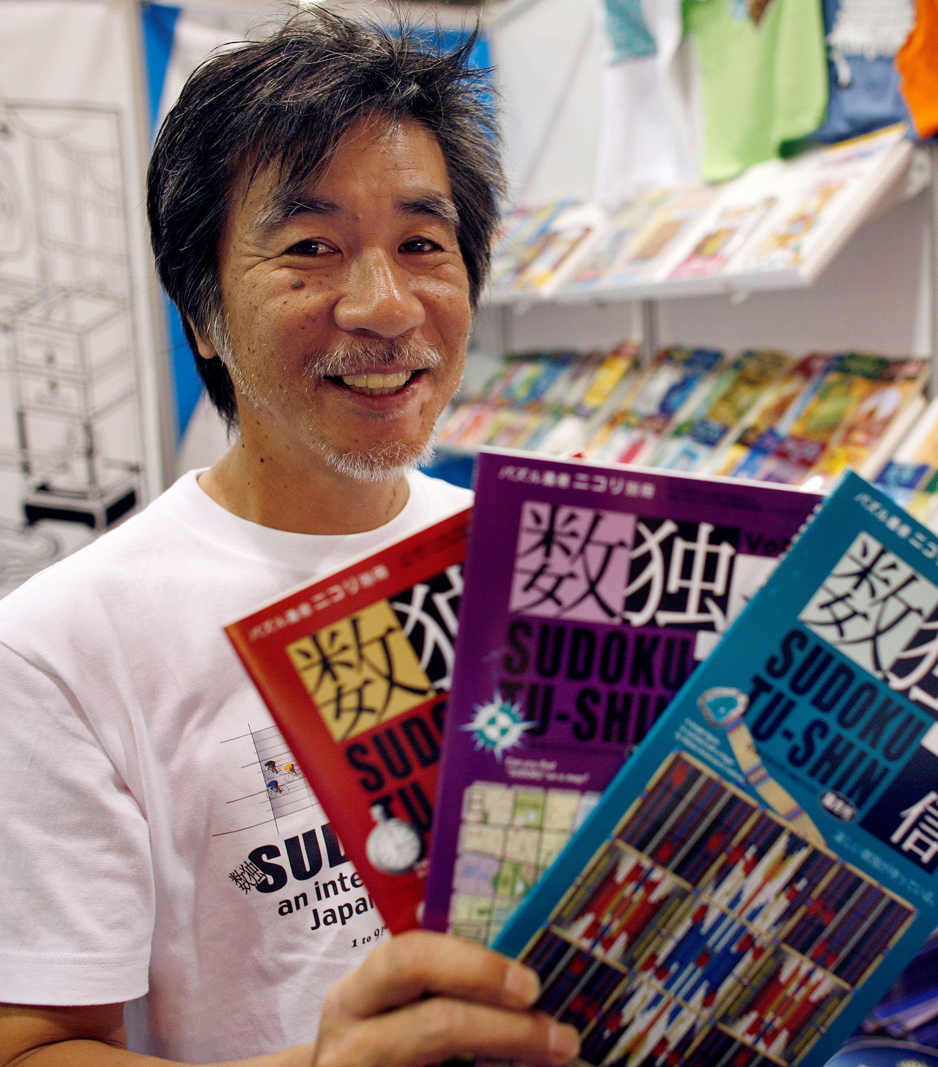 'Father of Sudoku' Maki Kaji holds copies of the latest sudoku puzzles at the Book Expo, in New York