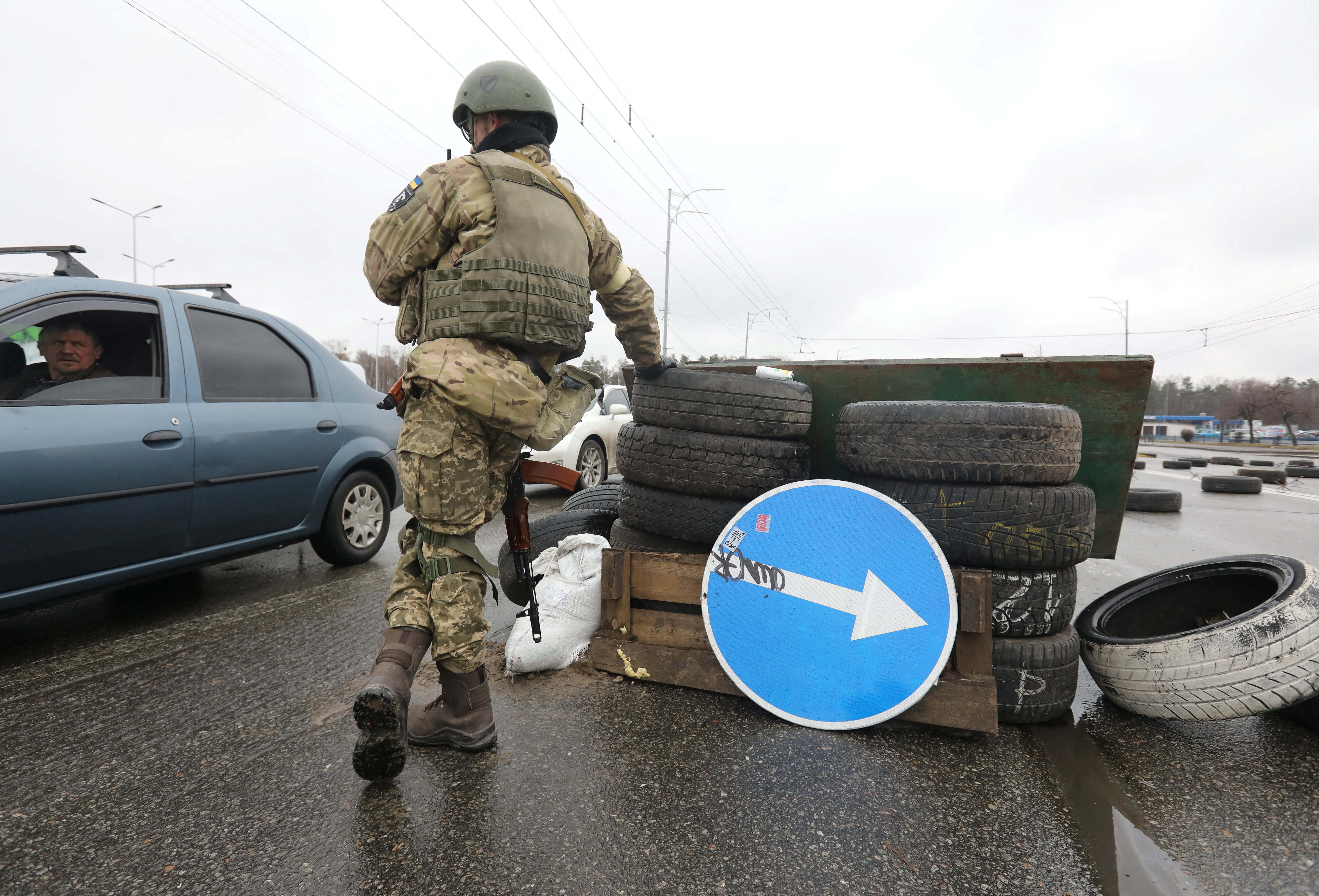 A member of the Territorial Defence Forces stands guard at a checkpoint in Kyiv
