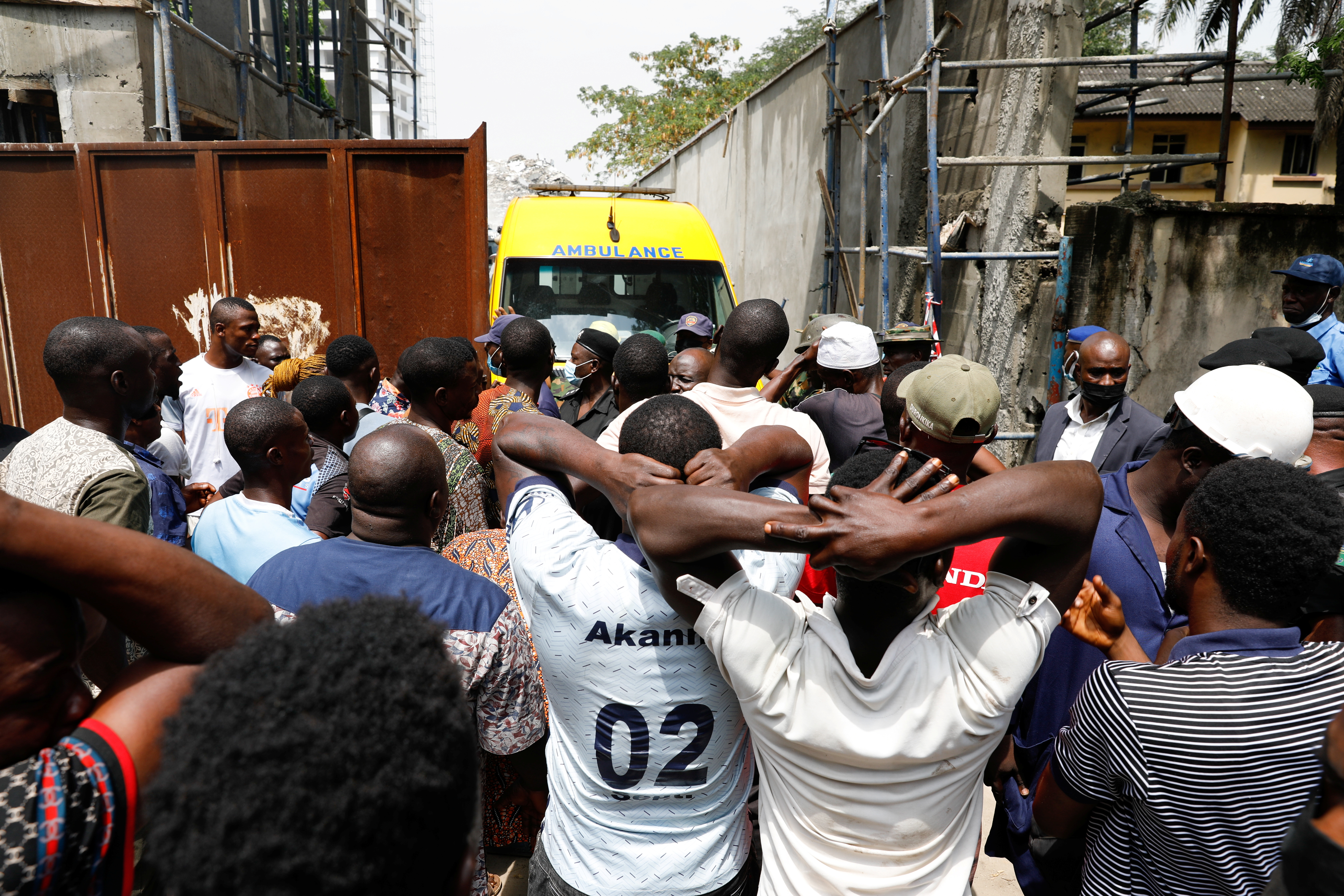 Relatives wait outside as rescue workers continue to conduct search and rescue effort at the site of a collapsed building in Ikoyi, Lagos, Nigeria, November 2, 2021. REUTERS/Temilade Adelaja