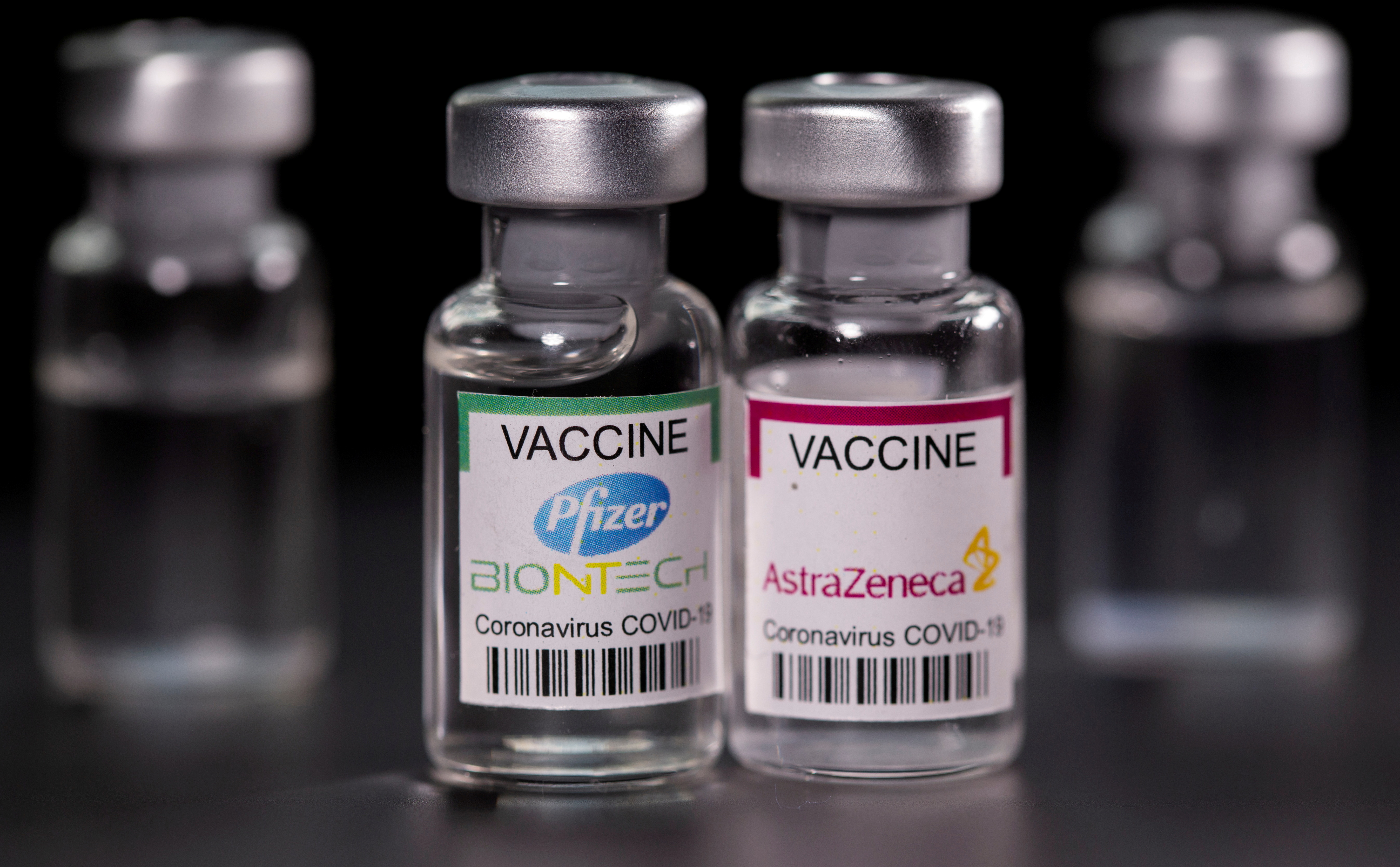 Picture illustration of vials with Pfizer-BioNTech and AstraZeneca coronavirus disease (COVID-19) vaccine labels