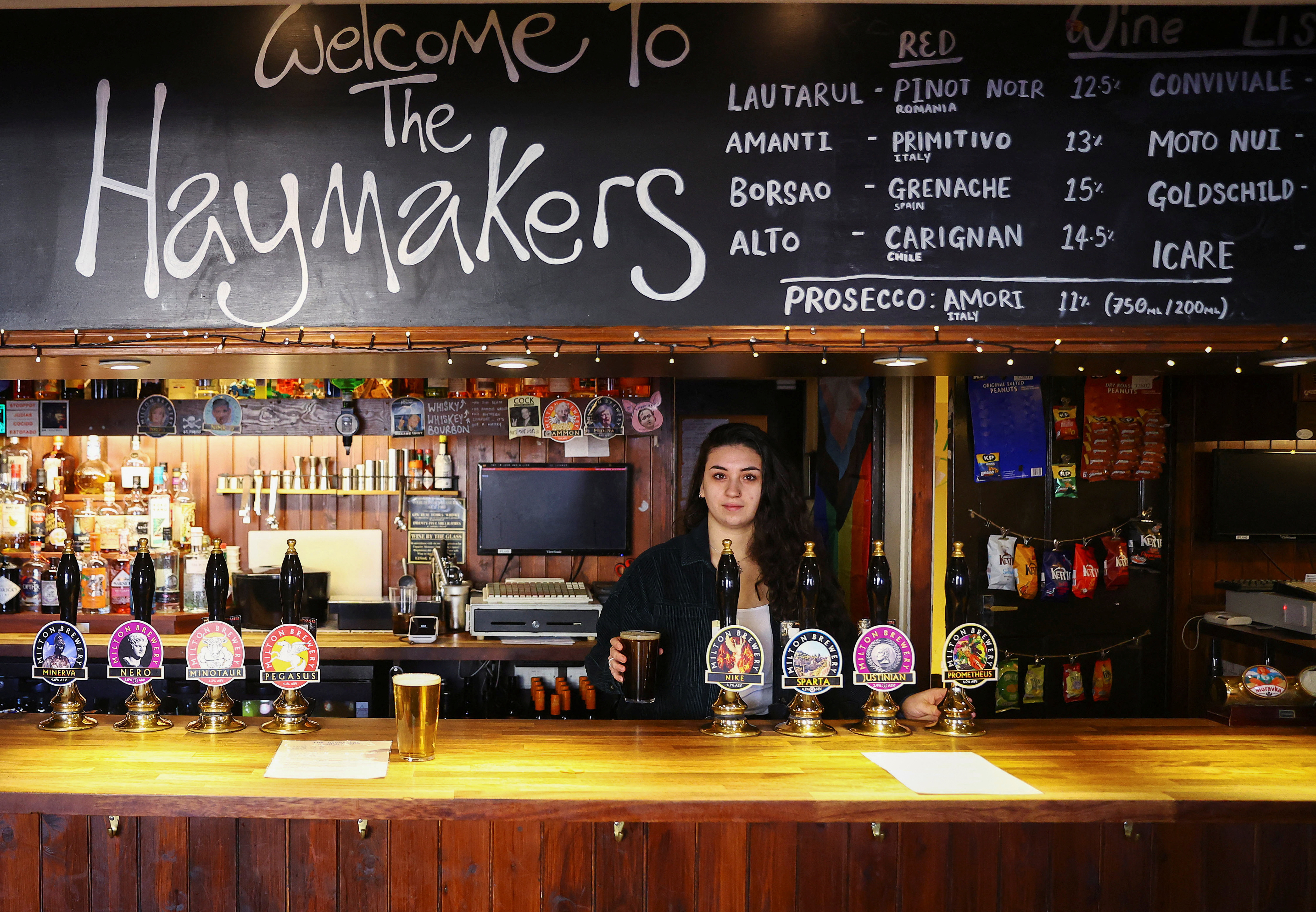 A barmaid pours a pint of Milton Brewery’s Minerva at the Haymakers pub, in Cambridge