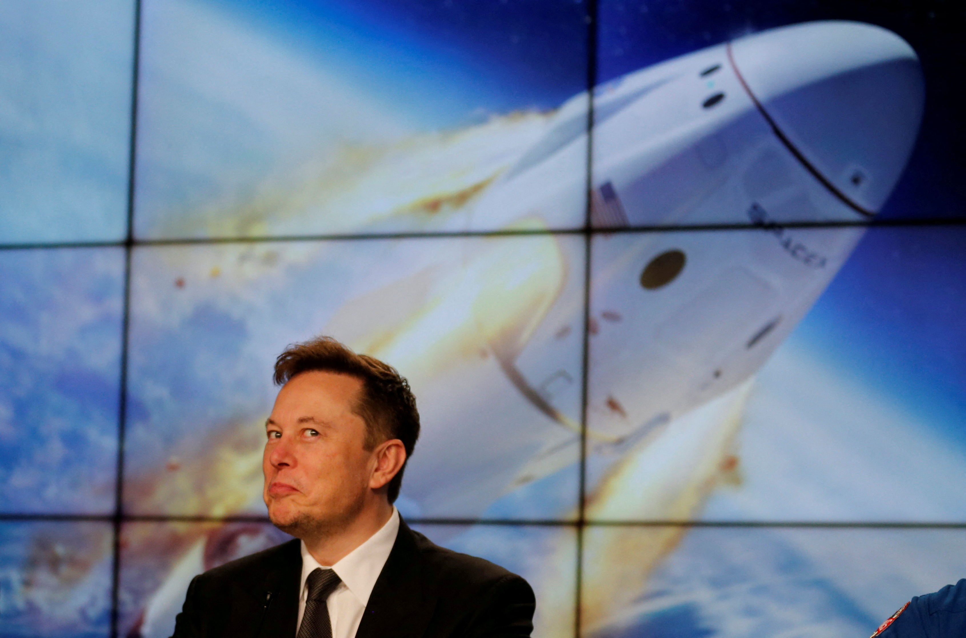 SpaceX founder and chief engineer Elon Musk reacts during a post-launch news conference to discuss the SpaceX Crew Dragon astronaut capsule in-flight abort test at the Kennedy Space Center