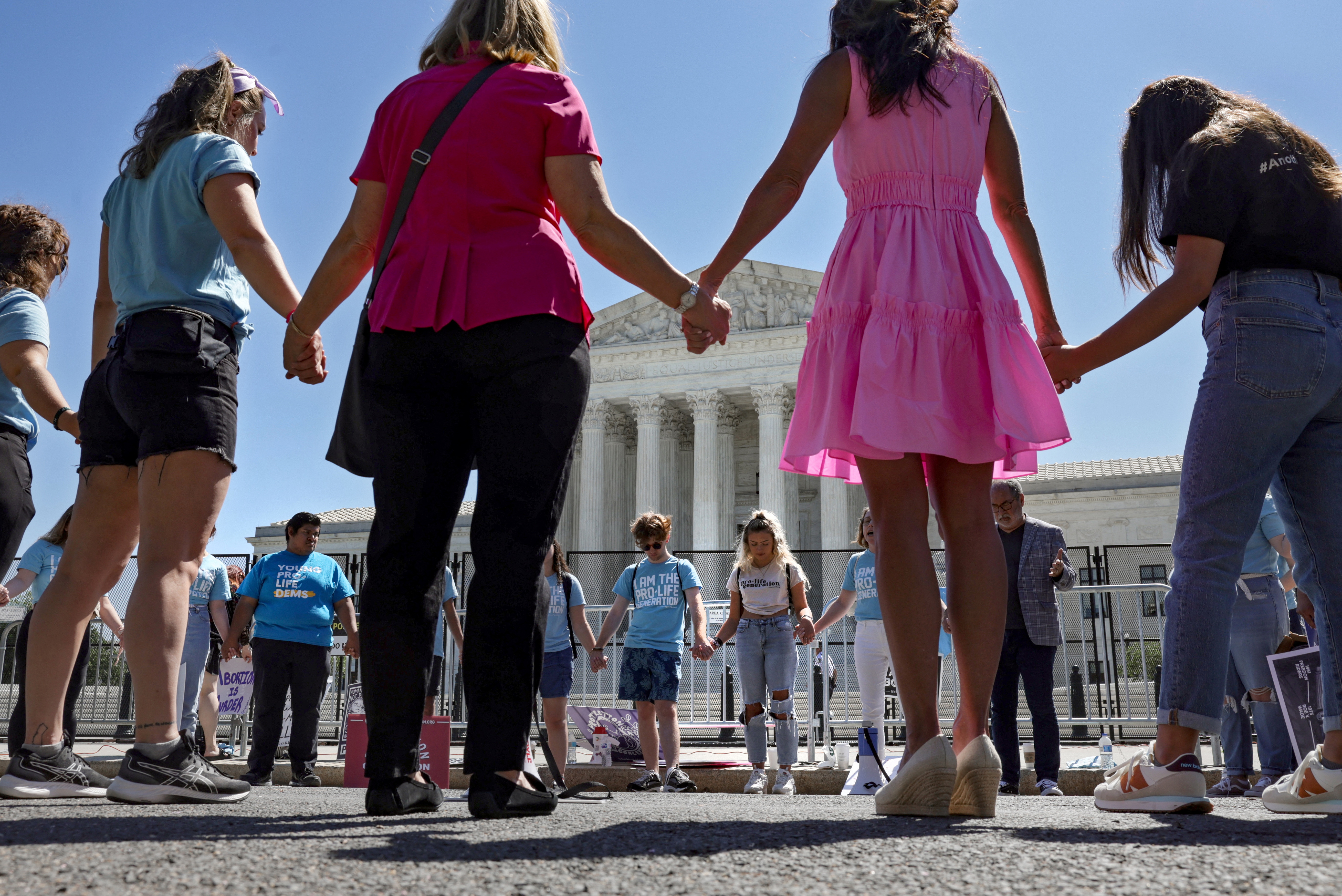 Anti-abortion protestors pray outside of the Supreme Court in Washington