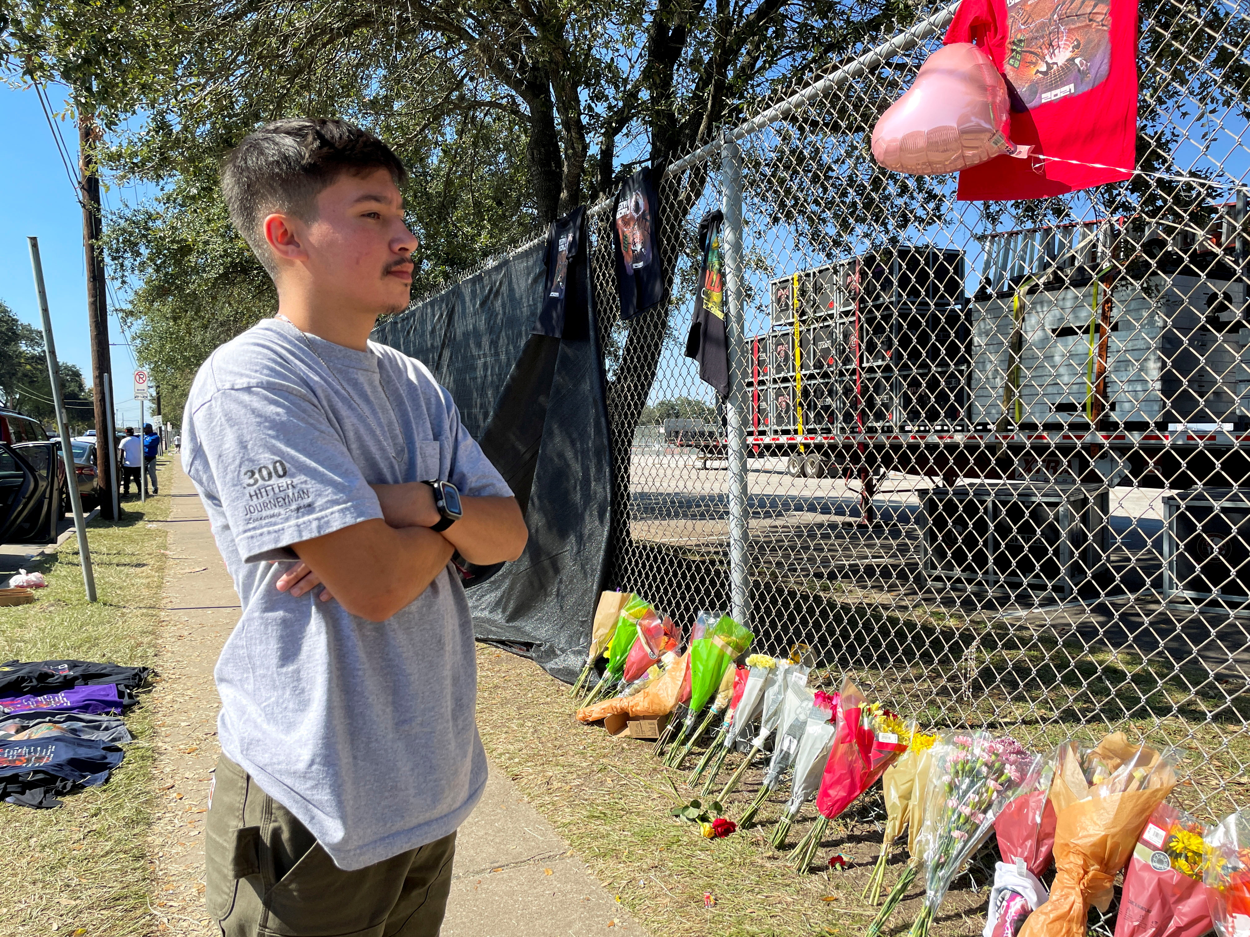 Maximiliano Alvarado, 20, of Houston, visits a makeshift memorial for the concertgoers who died in a stampede at the 2021 Astroworld Festival in Houston, Texas, U.S. November 7, 2021. REUTERS/Nathan Frandino/File Photo